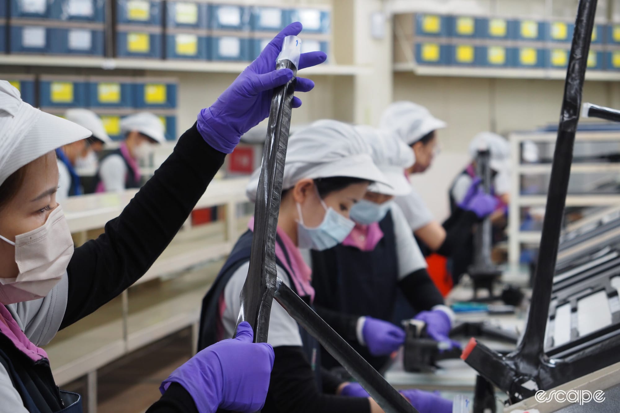 Carbon fibre factory, woman holding a bike frame