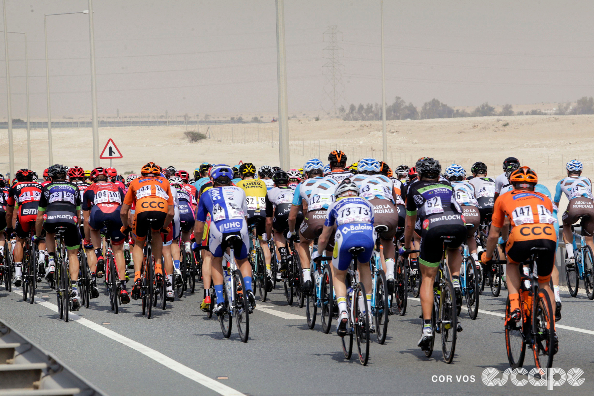 The professional peloton rides through the Qatari desert in a prior edition of the Tour of Qatar.
