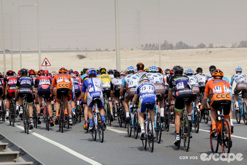 The professional peloton rides through the Qatari desert in a prior edition of the Tour of Qatar.
