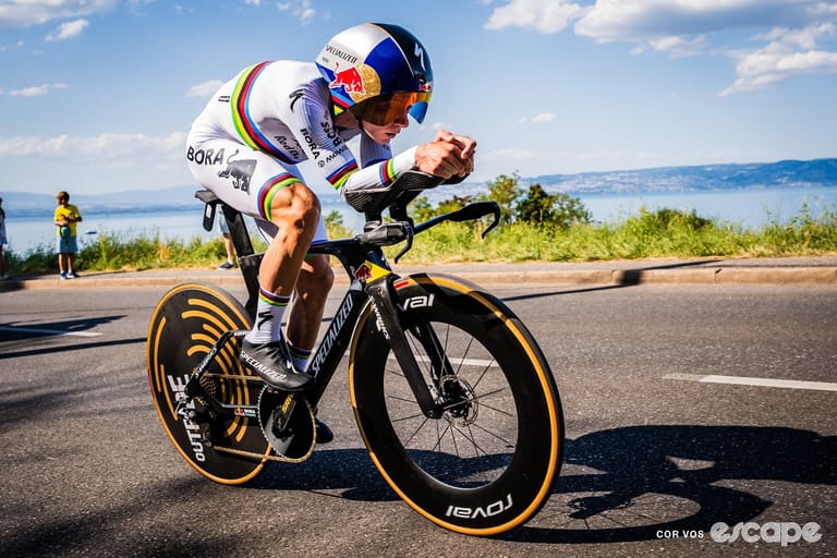 Remco Evenepoel is pictured riding his TT bike in world champion kit during the stage 16 time tri
