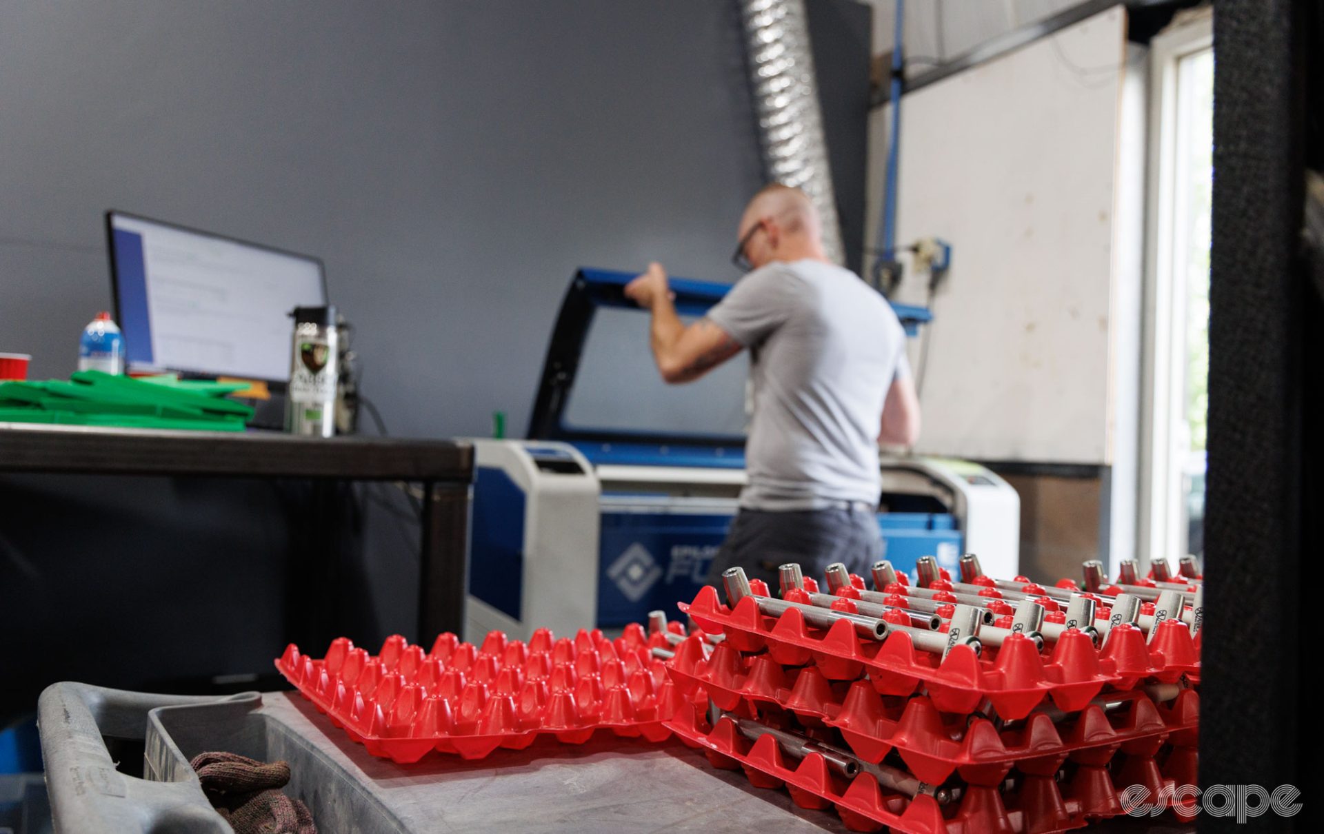 Mark is put to work on the laser engraver. Here a whole pile of T-handle tools await the bright light.