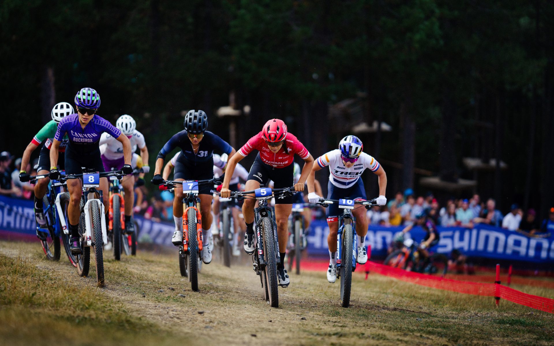 The front group of five riders in the women's world cup short track in Andorra climb a hill, led by eventual winner Alessantra Keller.