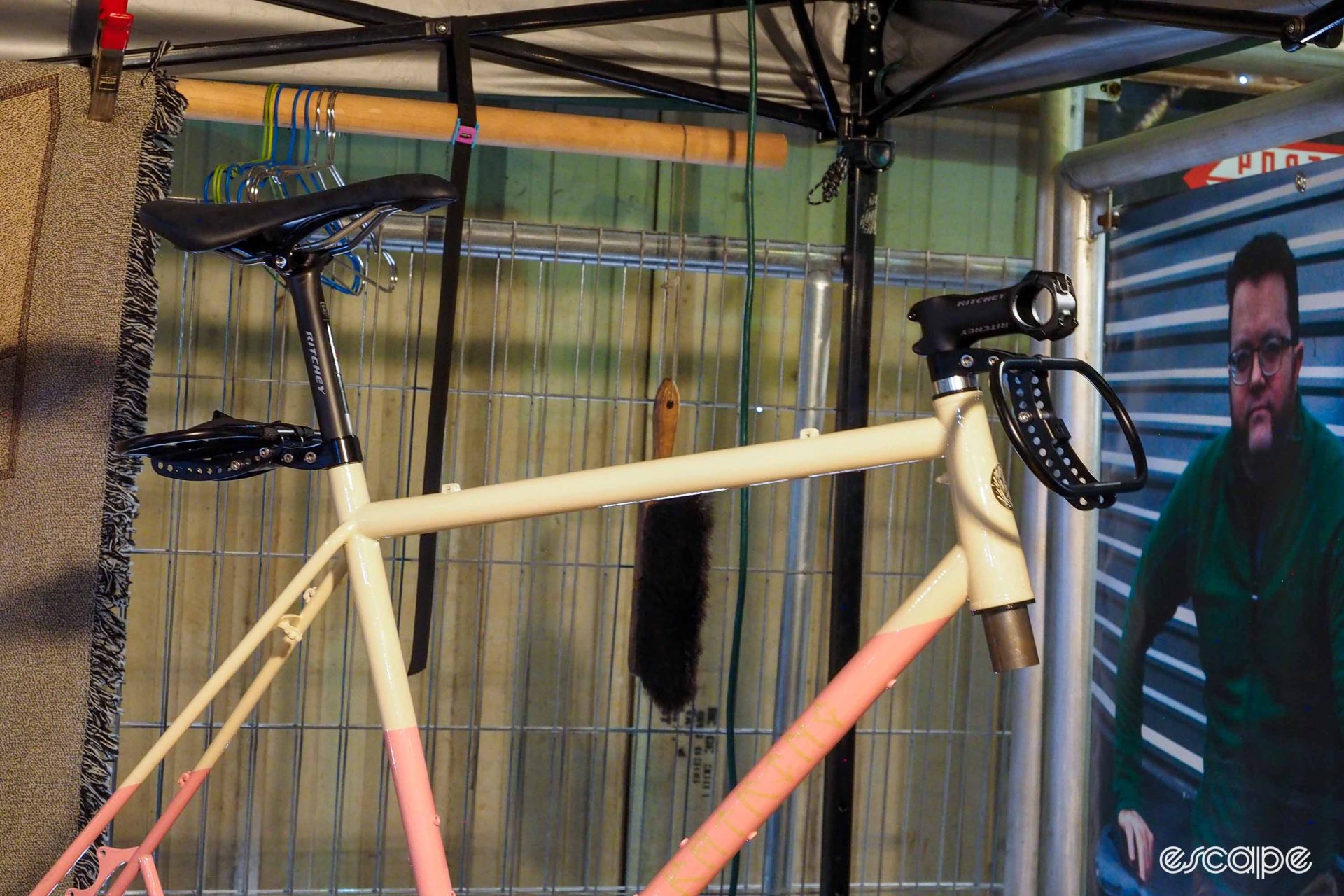 Ratking Frames The Cradle bikepacking rack on cream-and-pink steel frame.