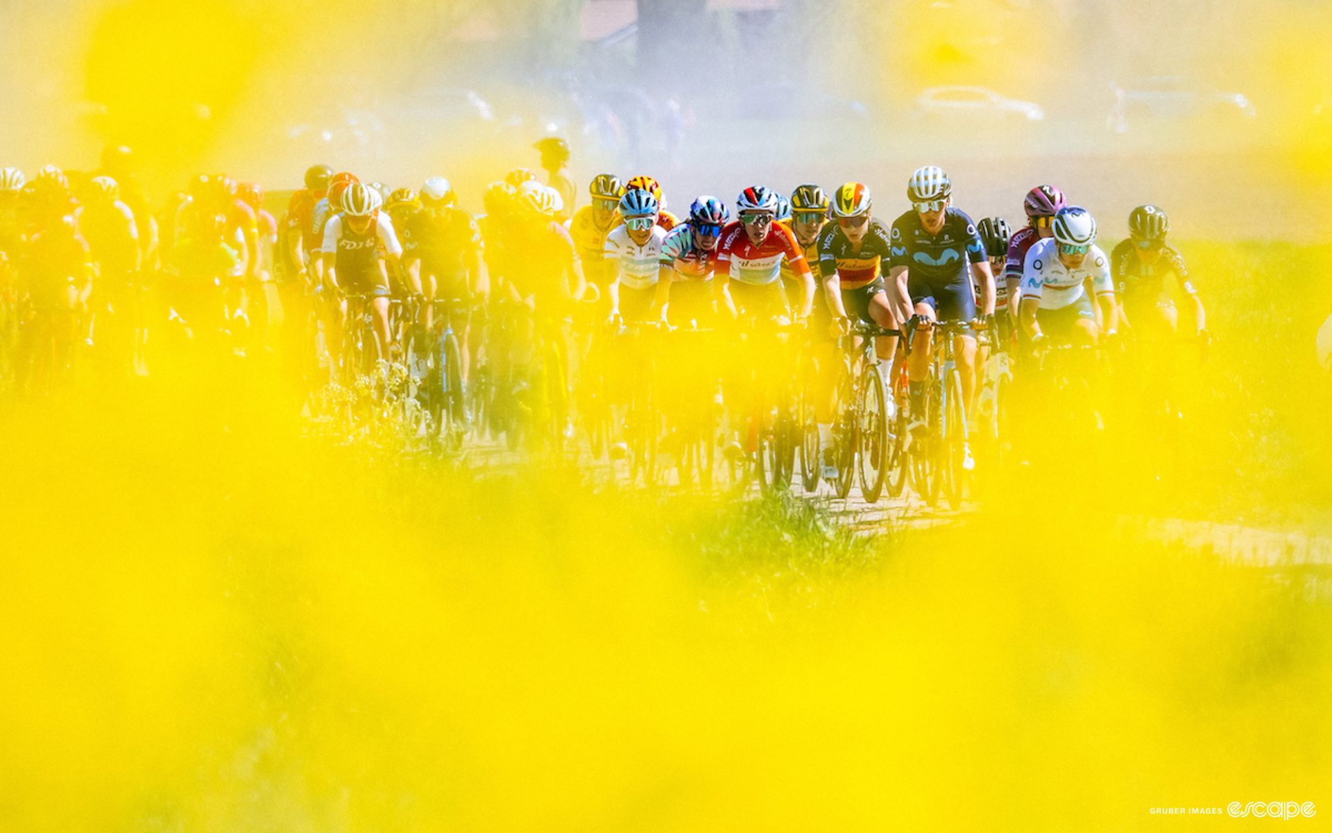 The peloton through flowers at the Tour de France Femmes.