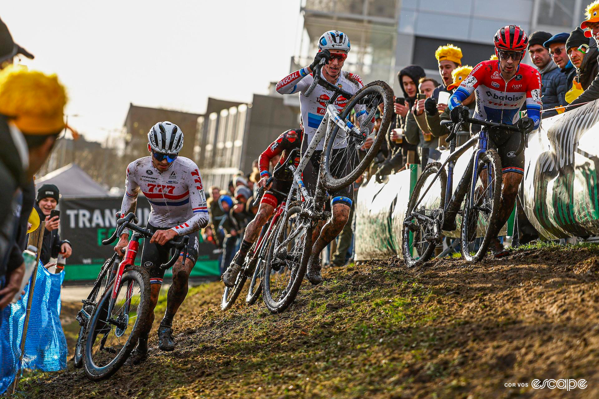 Cameron Mason, Michael Vanthourenhout and Lars van der Haar handle their bikes after coming down on the slippery off-camber section during X20 Trofee Kortrijk.