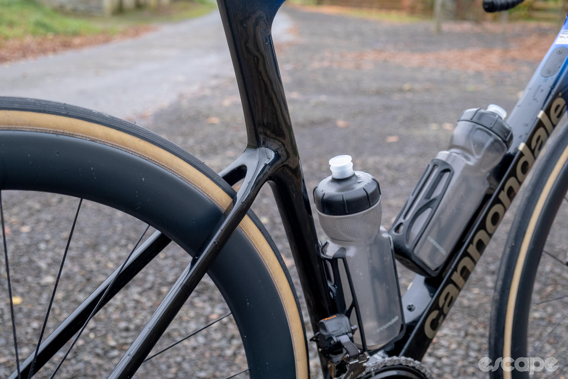 The photo shows the seat stay to aero profiled seat tube interface on a new Cannondale SuperSix Evo Hi-Mod 2 frame with Ultegra Di2 HollowGram and R-SL 50 wheelset pictured along a country lane in the background.