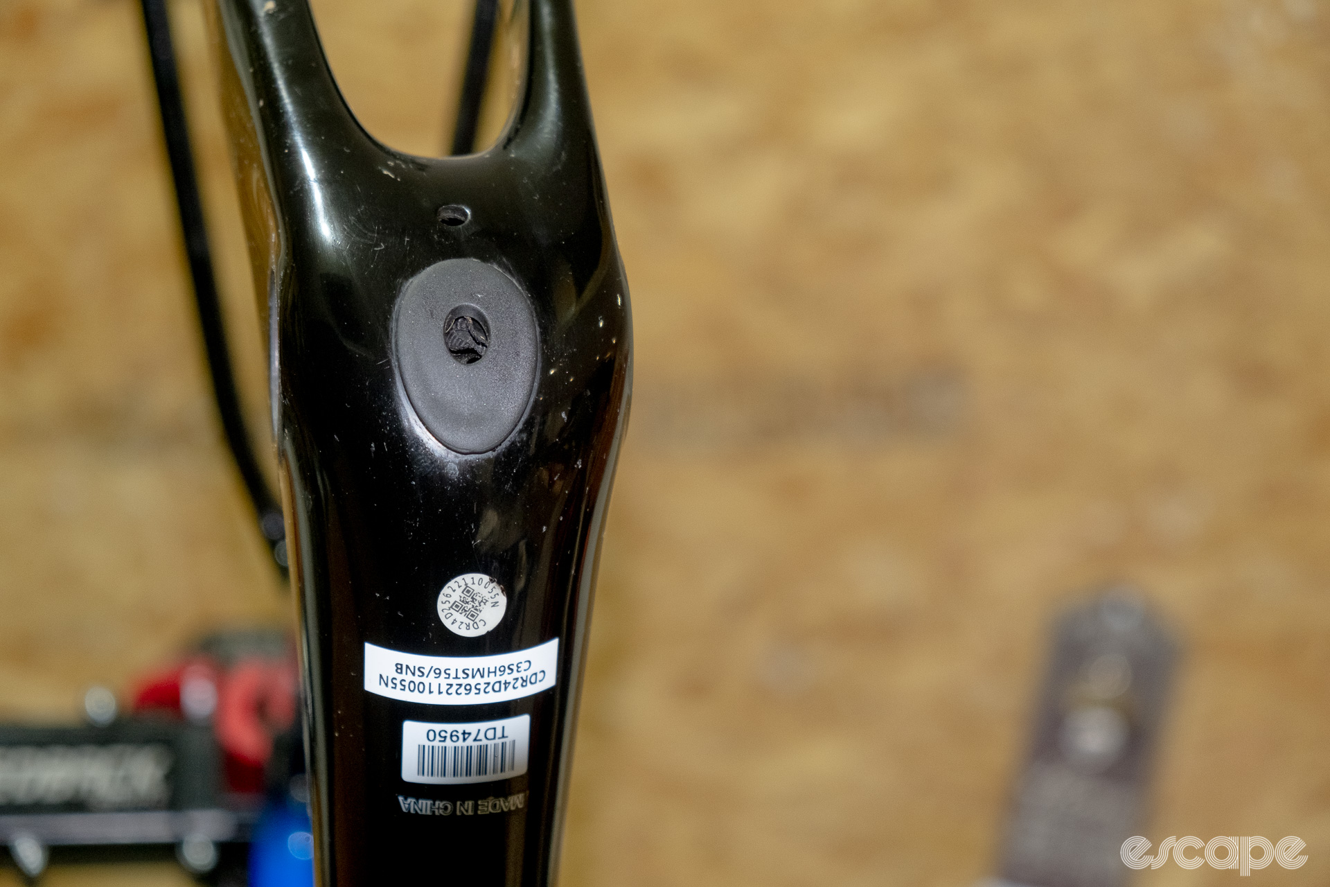 The photo shows the rubber battery port cover on a new Cannondale SuperSix Evo Hi-Mod 2.