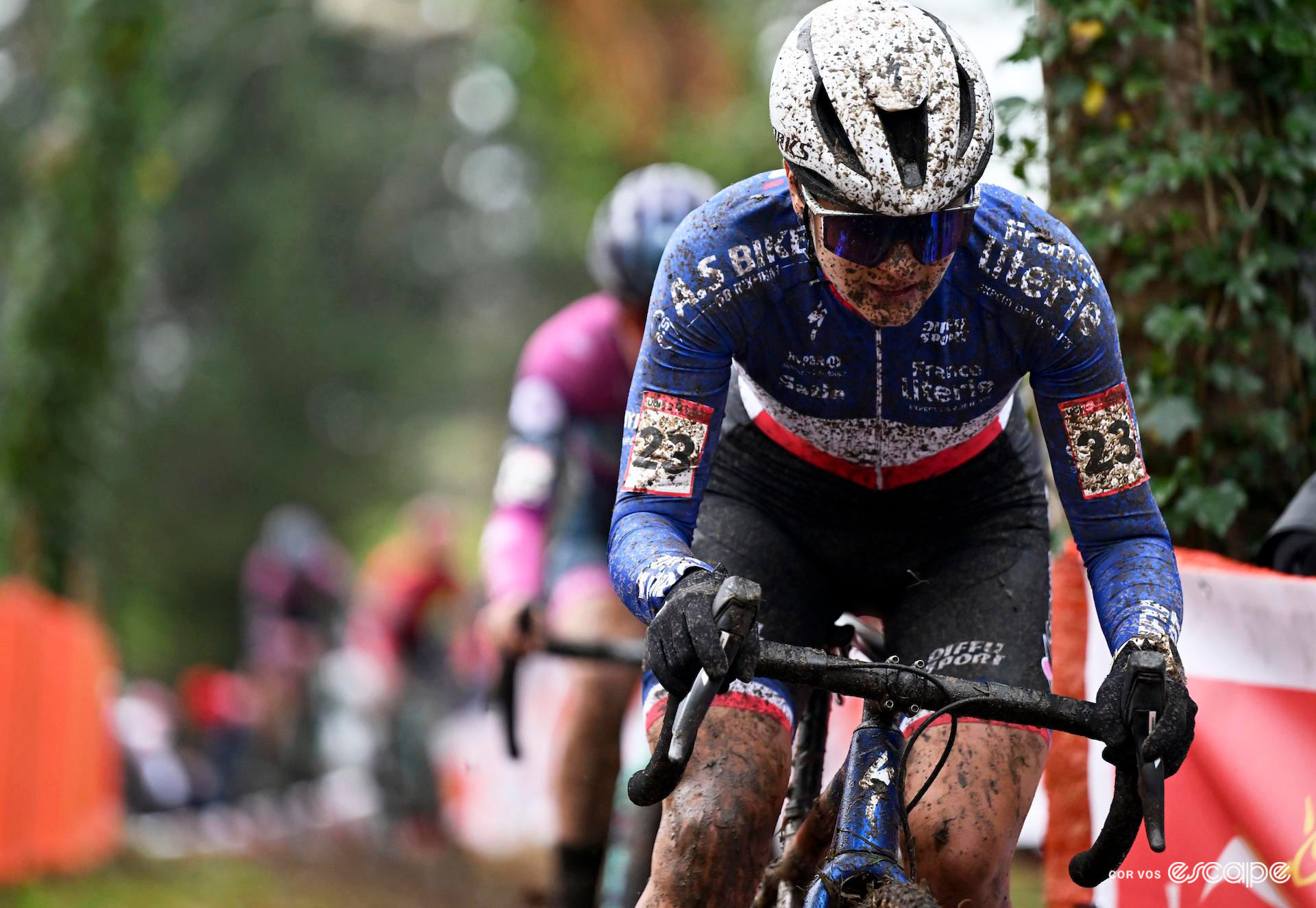 Mid shot of Hélène Clauzel in a mud-splattered French national champion's jersey during Cyclocross World Cup Flamanville.