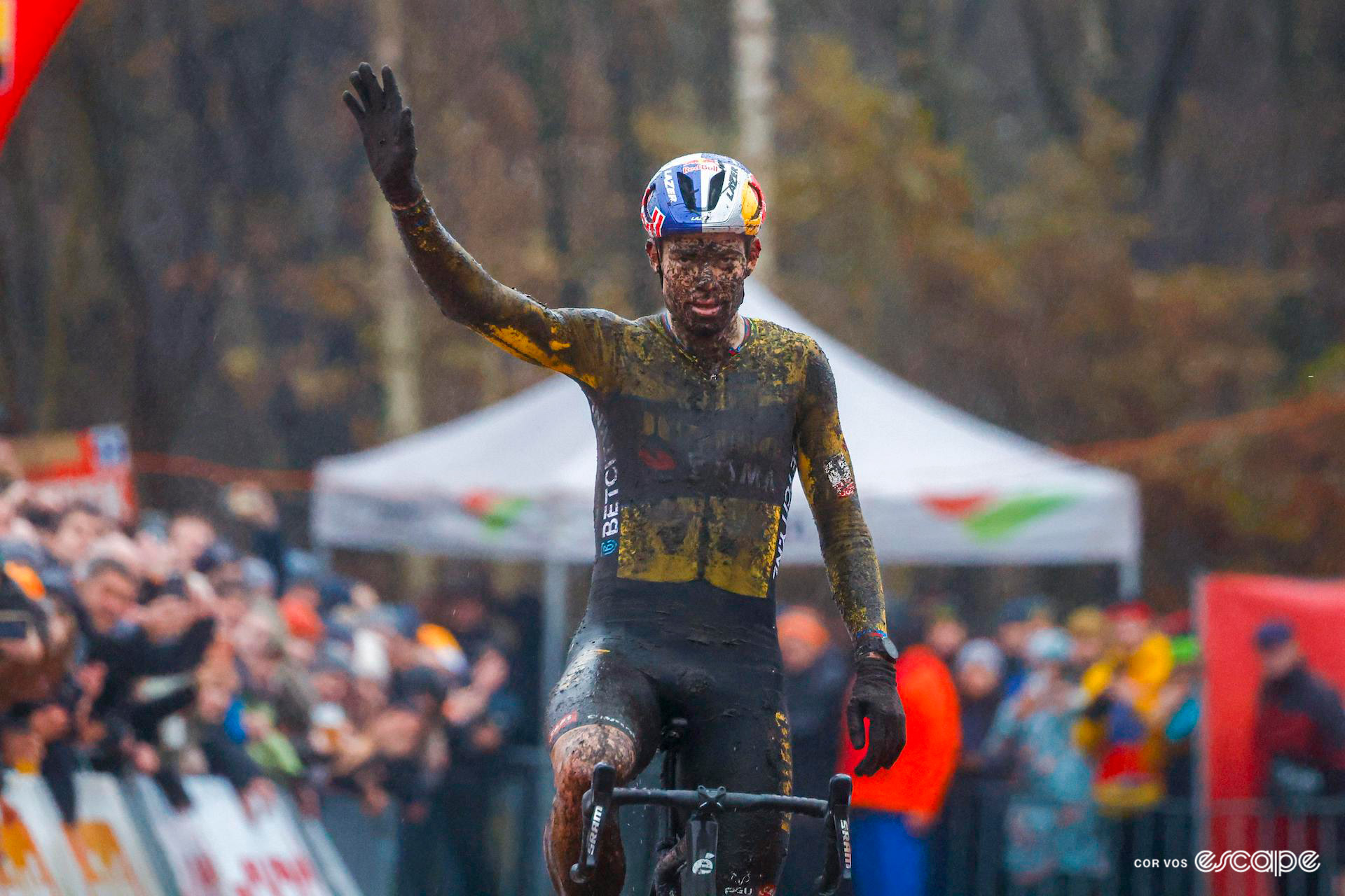 Wout van Aert celebrates winning a very wet and muddy Exact Cross Essen.