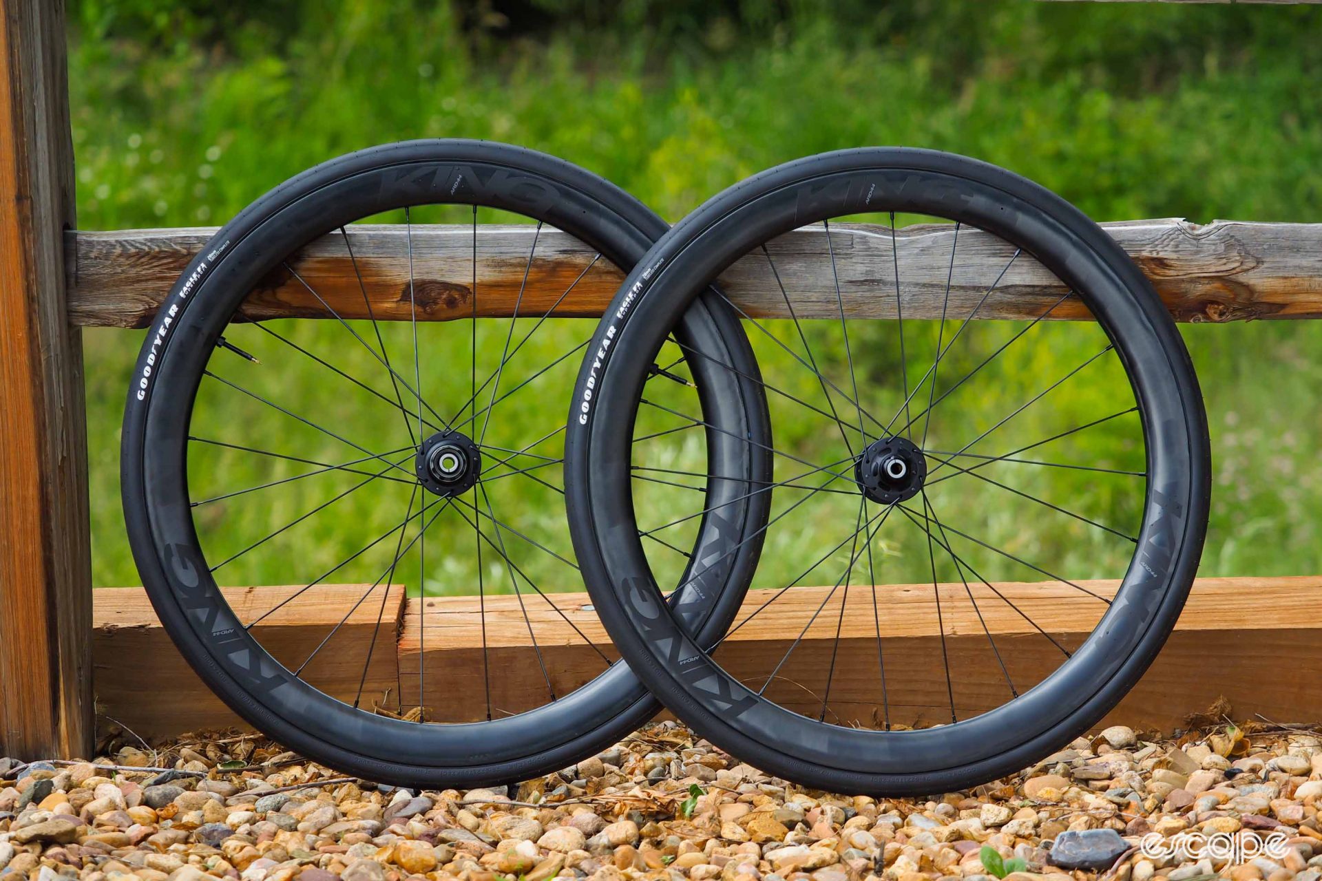 Chris King ARD44 wheelset leaning against wooden fence