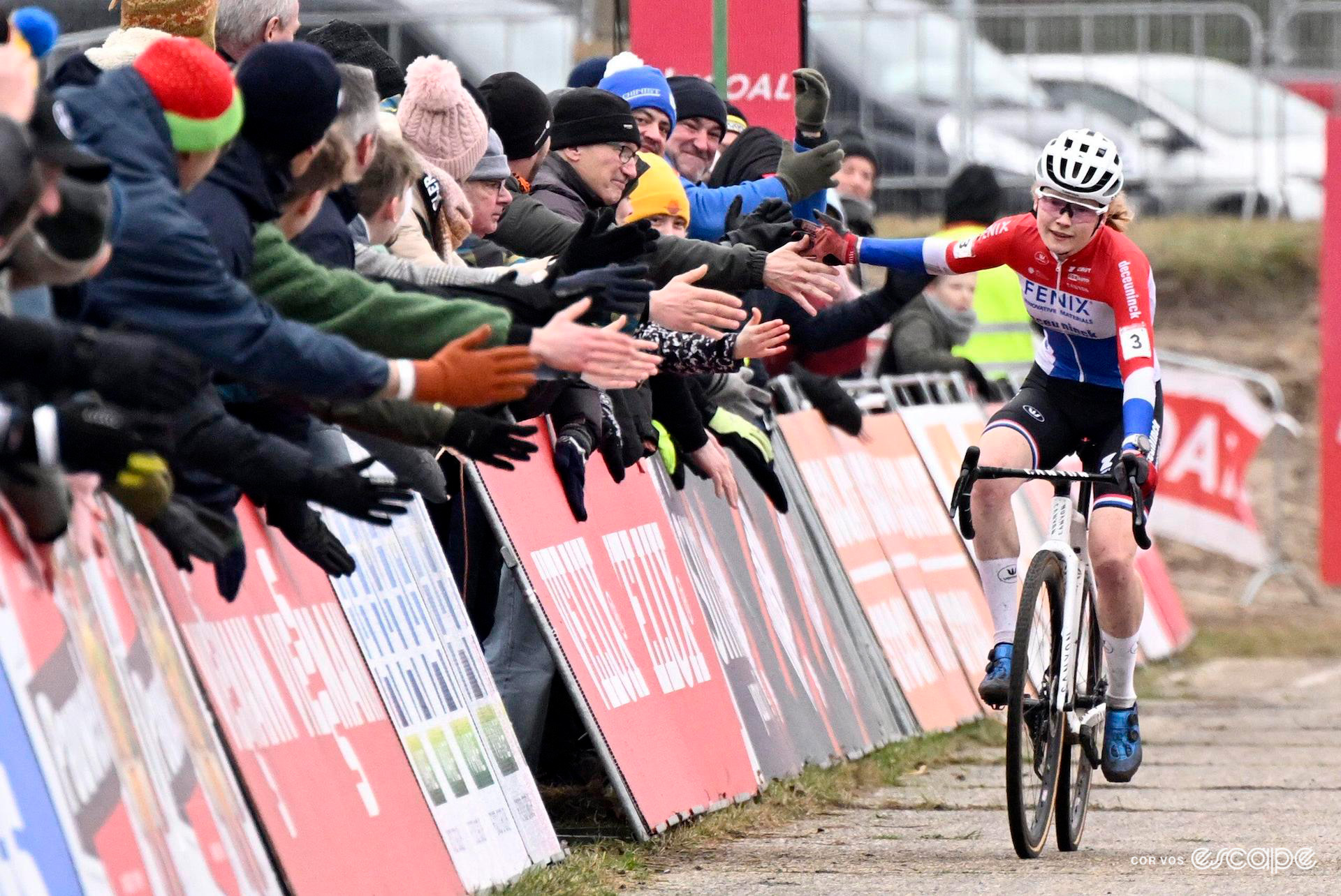 Dutch national champion high-fives the crowd along the finishing straight as she rides to victory at UCI World Cup Zonhoven.