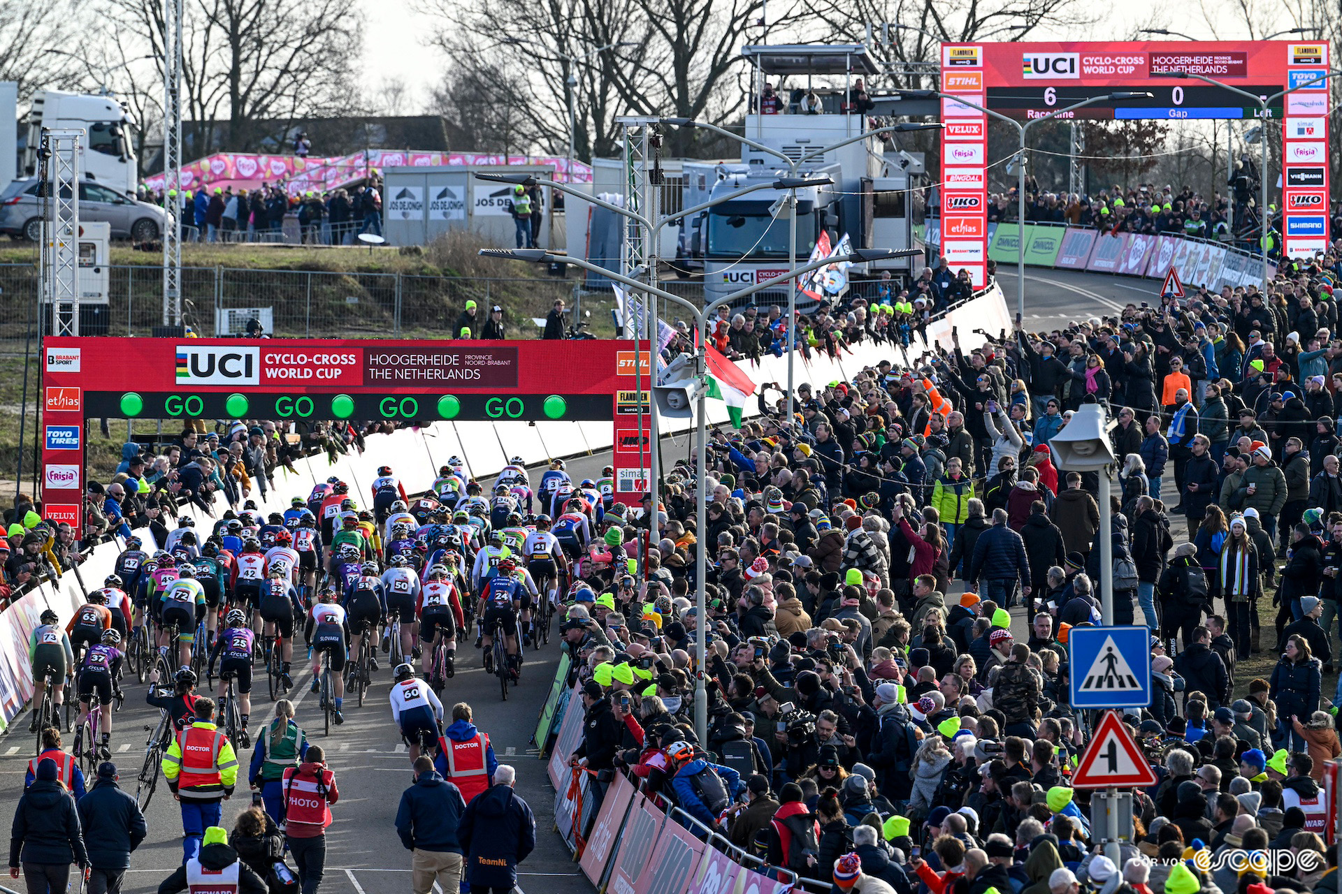 A wide shot of the elite women's start at CX World Cup Hoogerheide as a huge crowd watches.