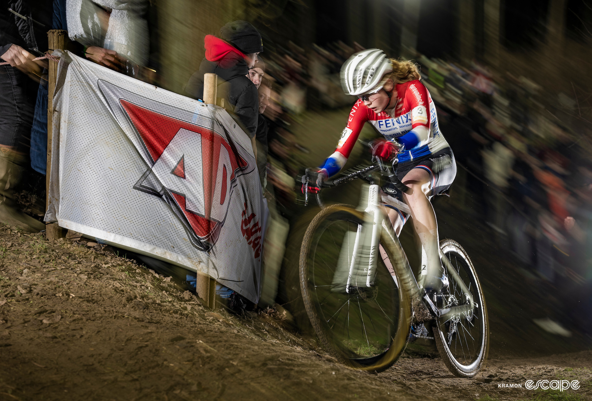 Puck Pieterse racing under floodlights at the nighttime Superprestige Diegem.