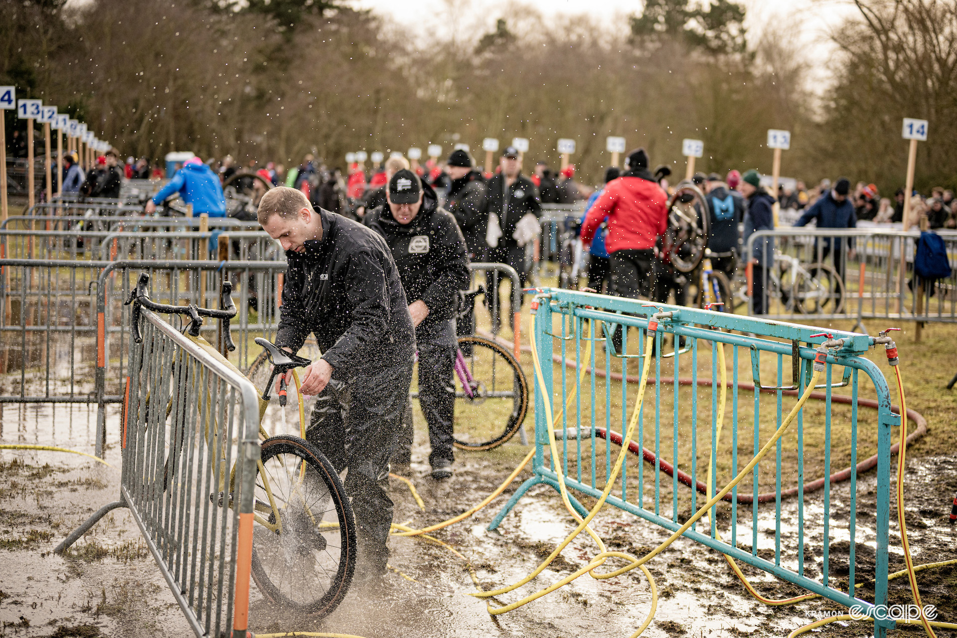 Team staff and helpers wash bikes behind the pits during X2O Trofee Koksijde - Vlaamse Duinencross.