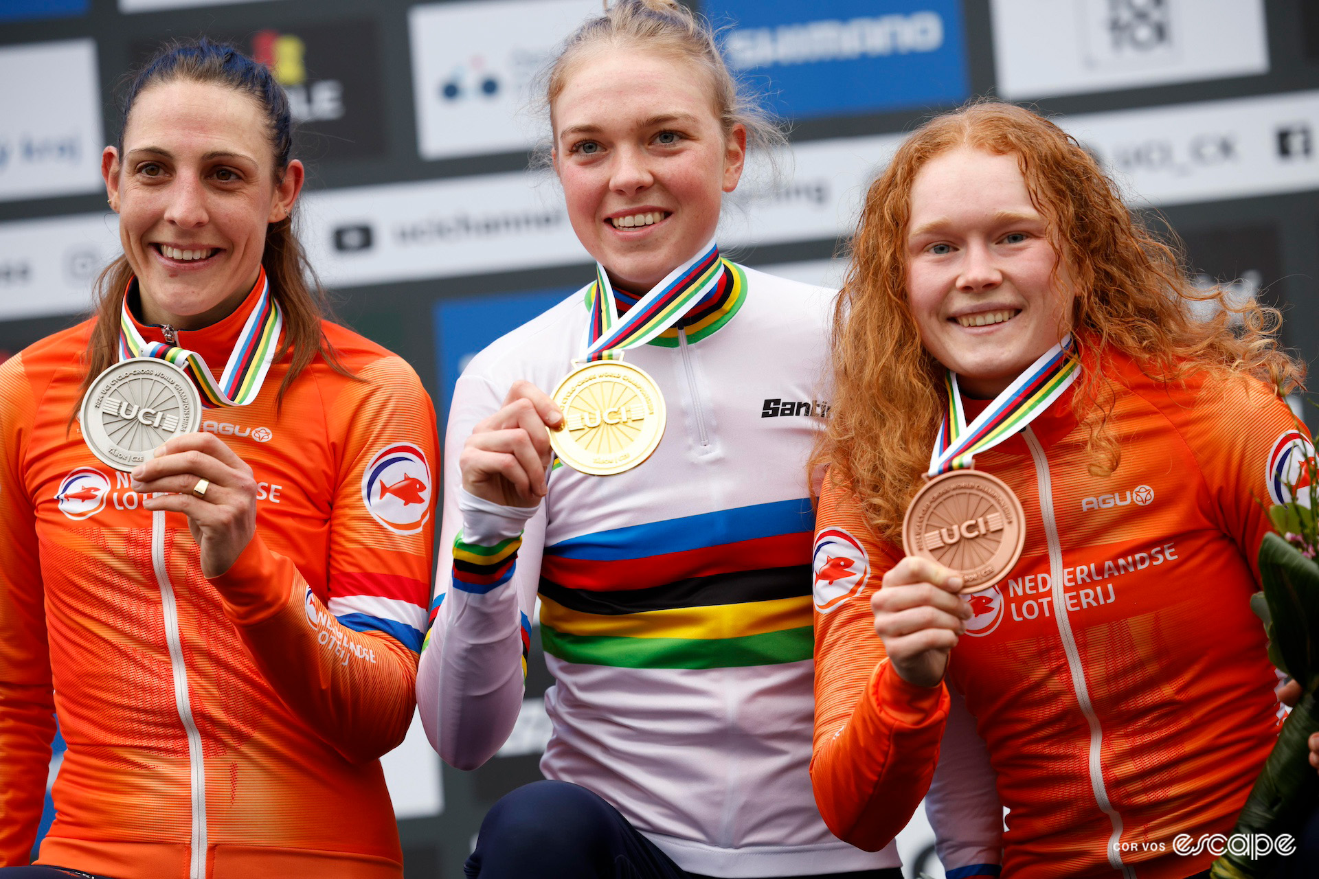 Fem van Empel, wearing a fresh rainbow jersey, flanked by Dutch compatriots runner-up Lucinda Brand and bronze medalist Puck Pieterse on the elite women's podium at the 2024 Cyclo-Cross World Championships in Tábor.