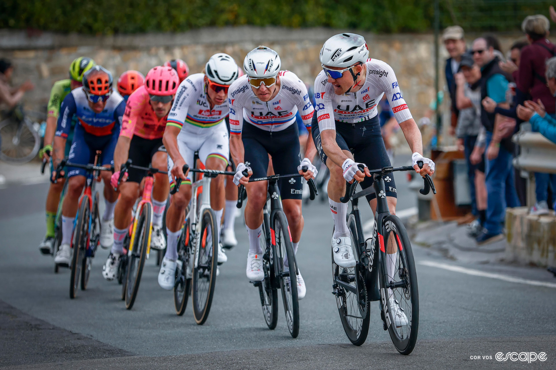 Tim Wellens looks over his shoulder as Tadej Pogačar prepares to attack the favourites during Milan-San Remo 2024.