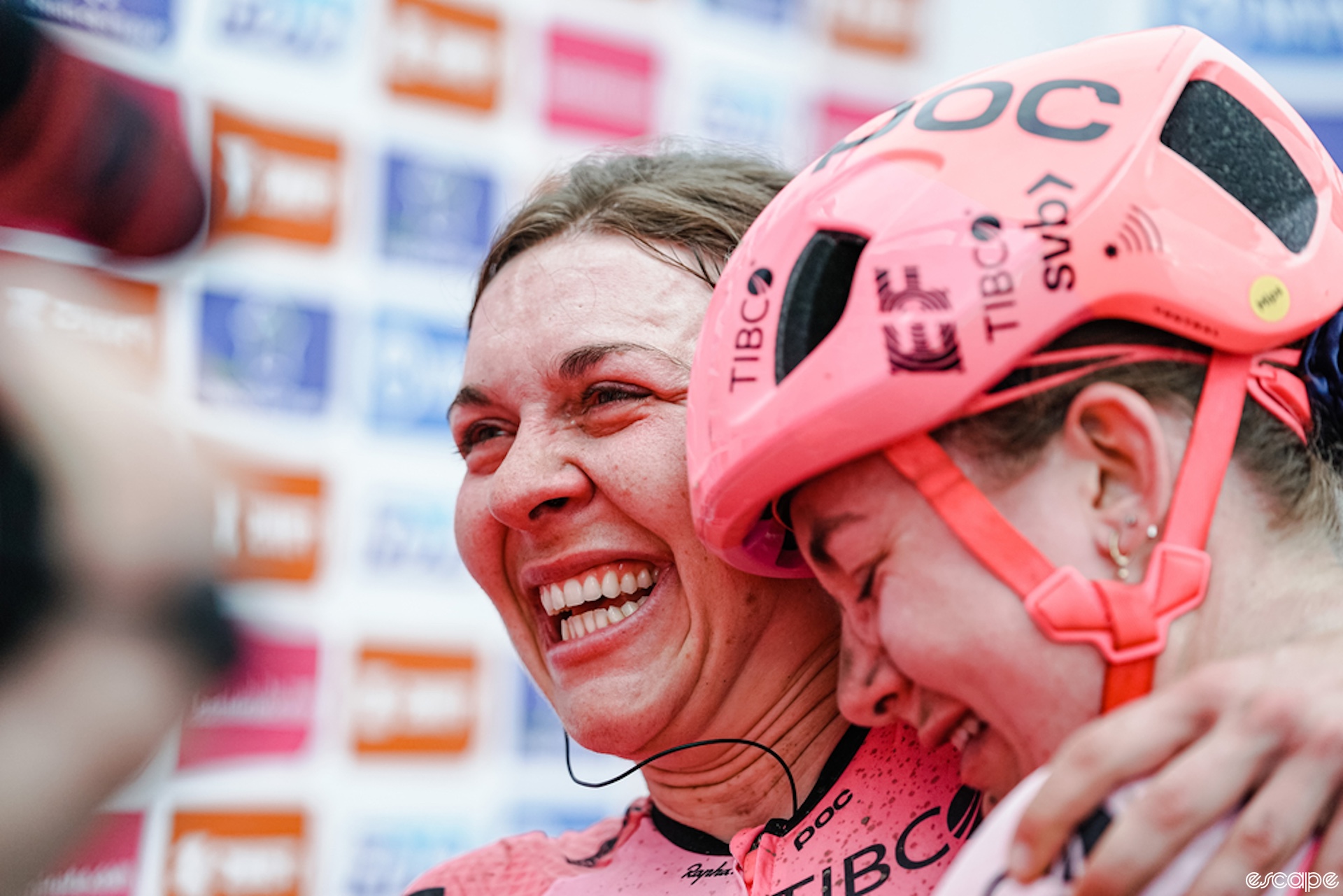 Two women hug after a bike race