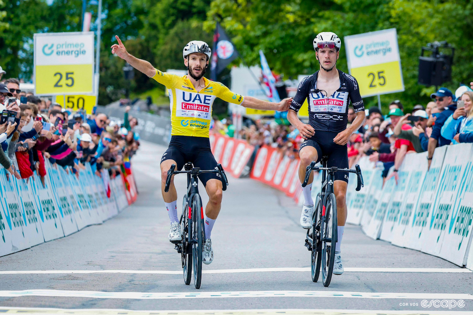 Adam Yates in the yellow jersey celebrates alongside teammate João Almeida as they finish first and second on stage 7 of the 2024 Tour de Suisse.