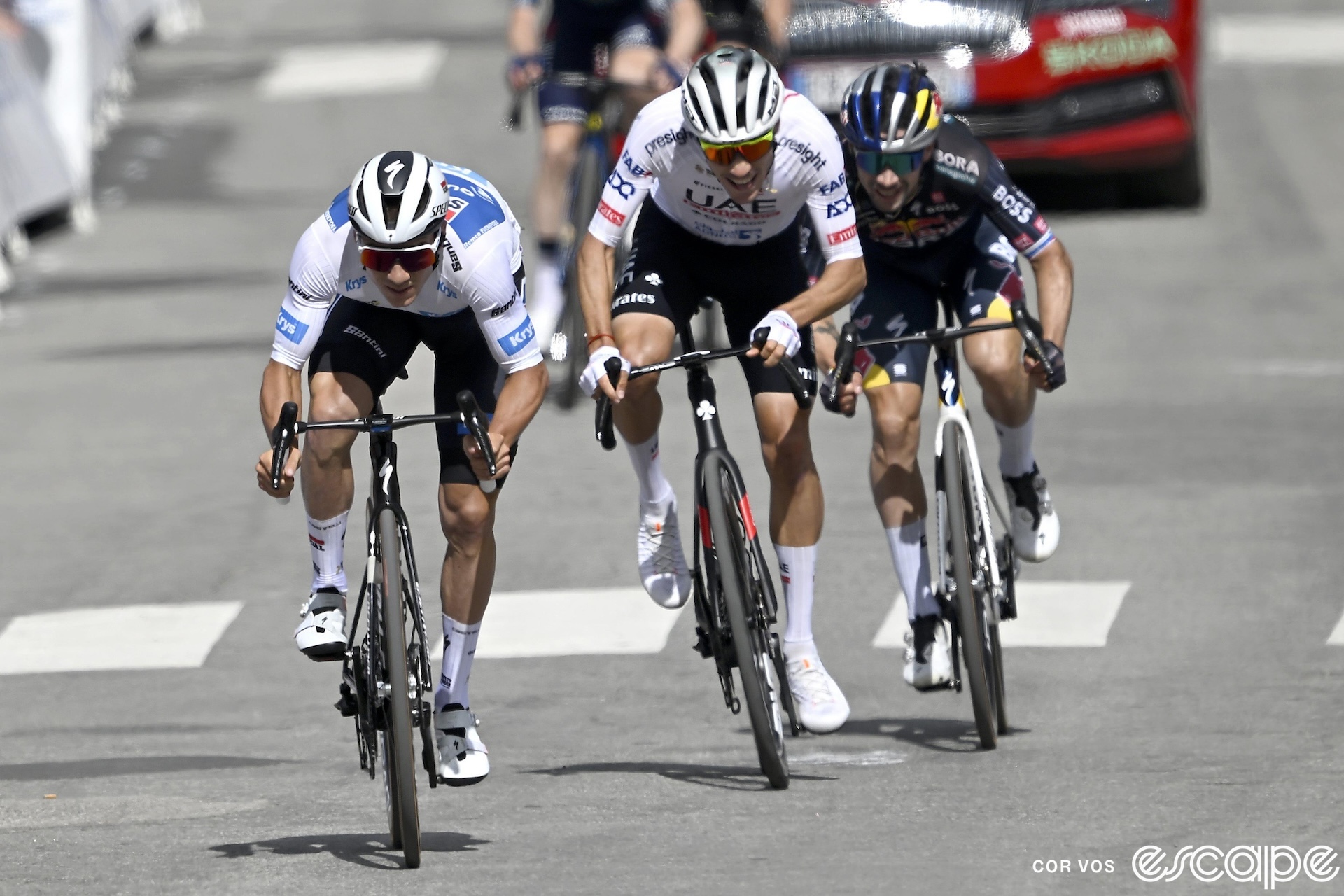 Remco Evenepoel leads a select group of chasers to the line on stage 4 of the 2024 Tour de France. He's out of the saddle ahead of Juan Ayuso and Primož Roglič as they come to the line.