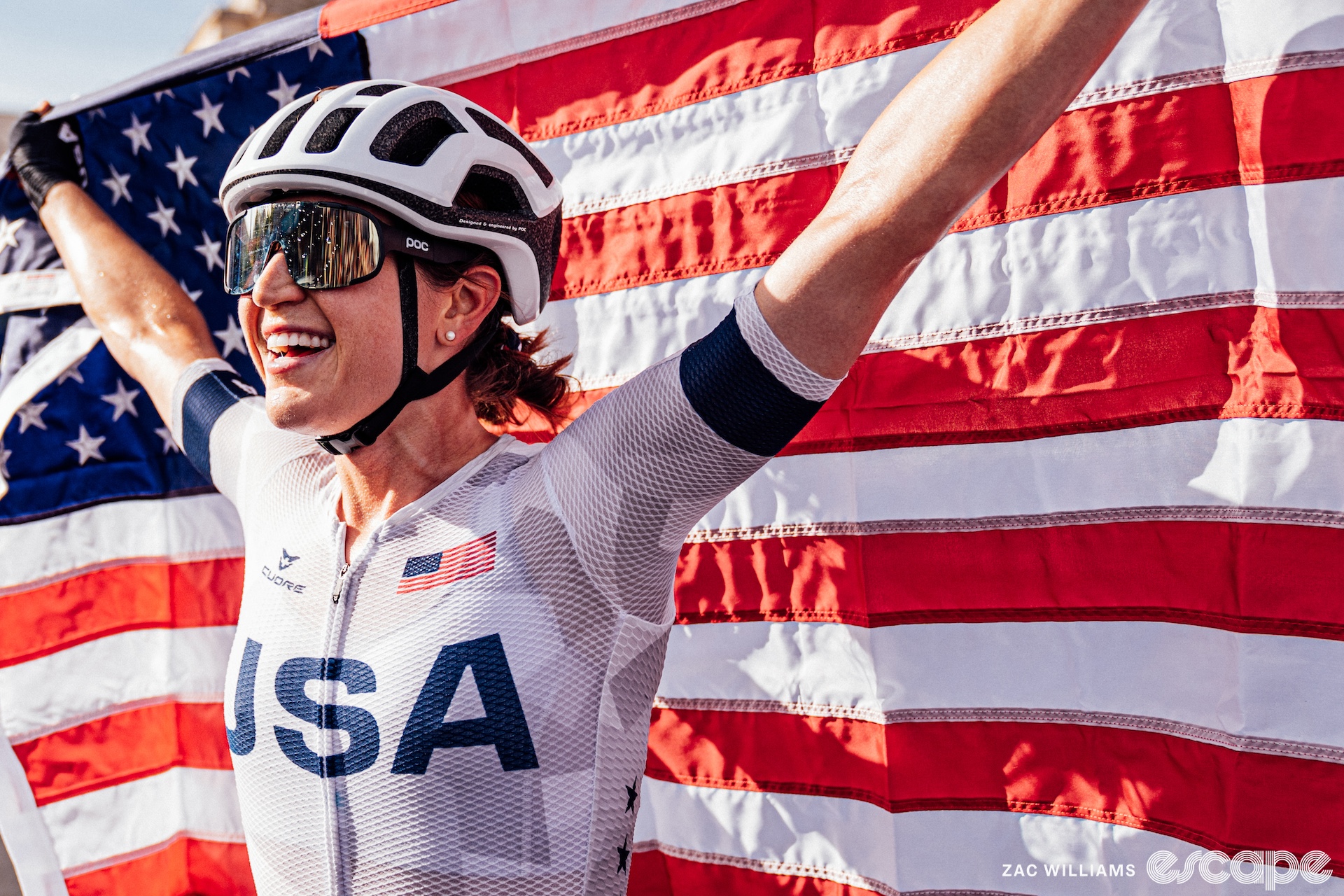 Kristen with an american flag after winning the olympic road race