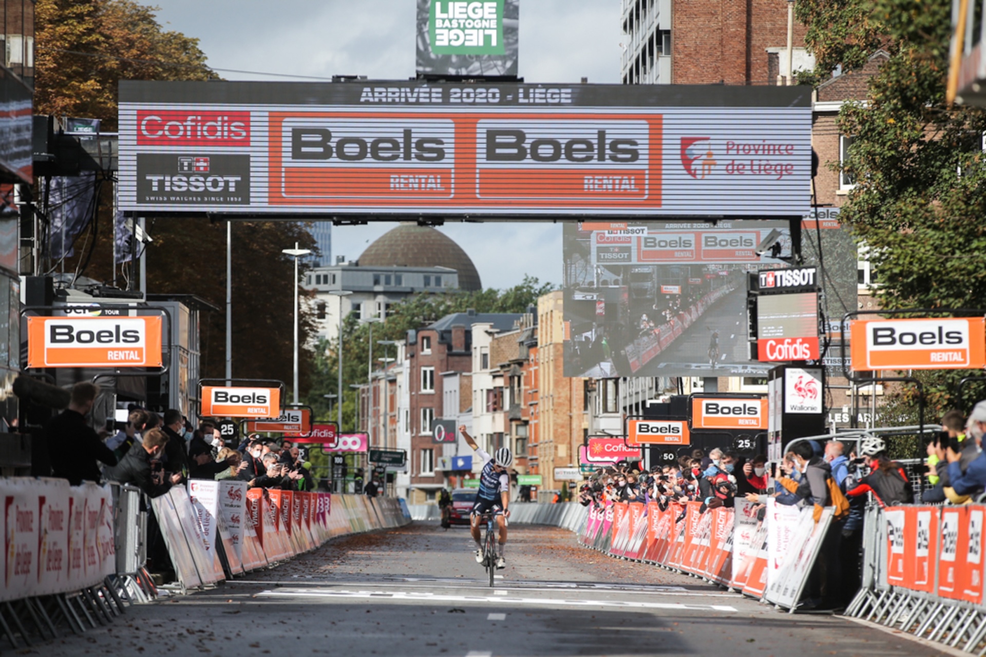 A wide shot of Deignan crossing the finish line solo