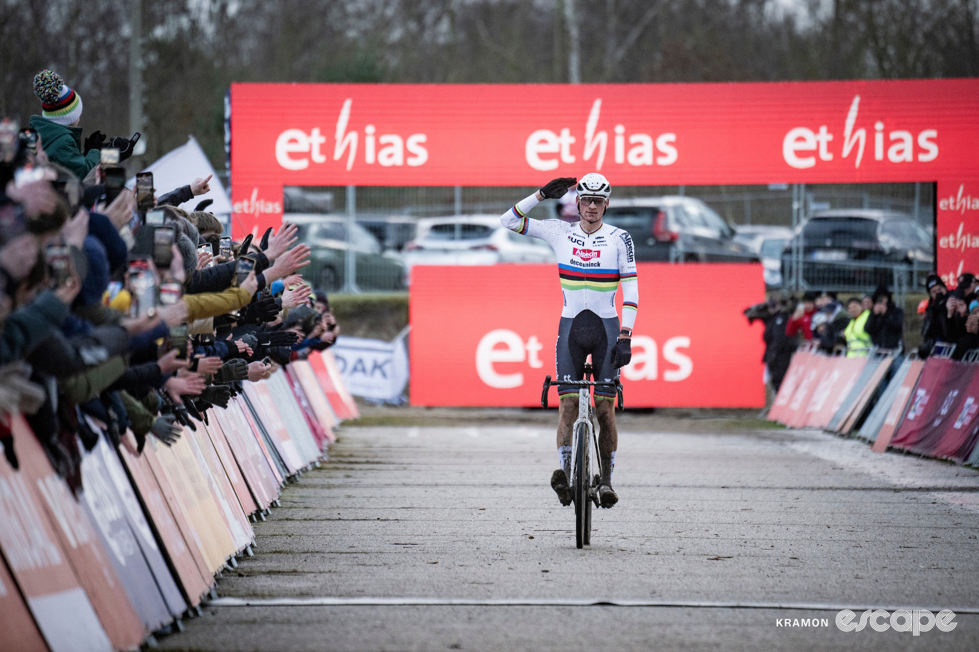 Elite world champion Mathieu van der Poel offers a salute as he stands on the pedals to celebrate victory at cyclocross World Cup Zonhoven.