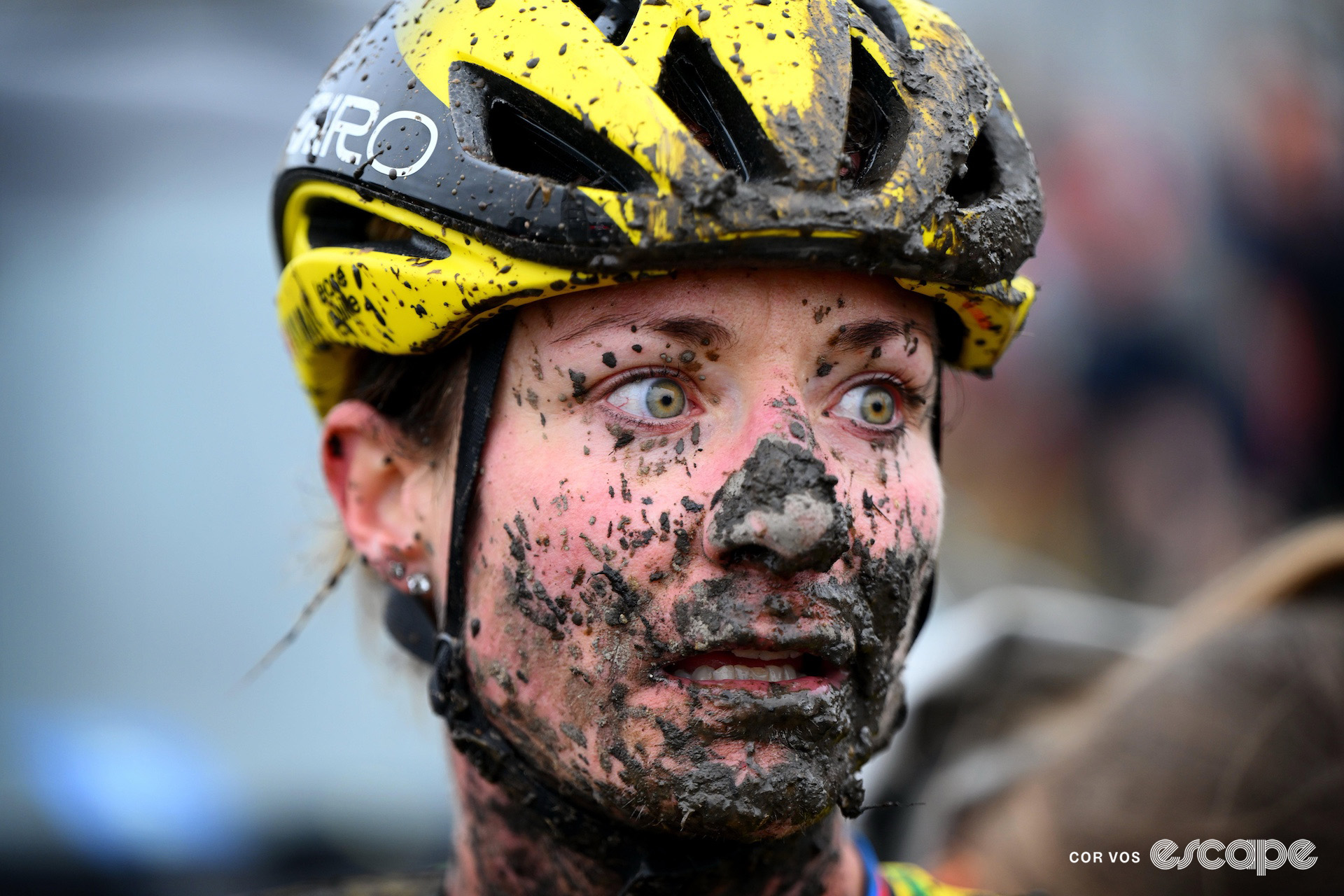 Marianne Vos stares into the distance, her face splattered with mud, after finishing cyclocross World Cup Maasmechelen.