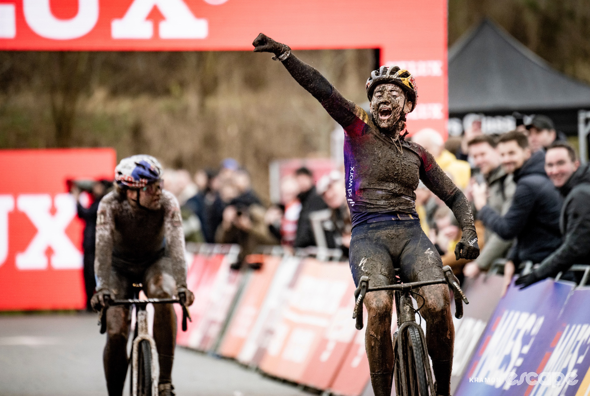 A muddy Blanka Vas punches the air in celebration of victory at cyclocross World Cup Maasmechelen.