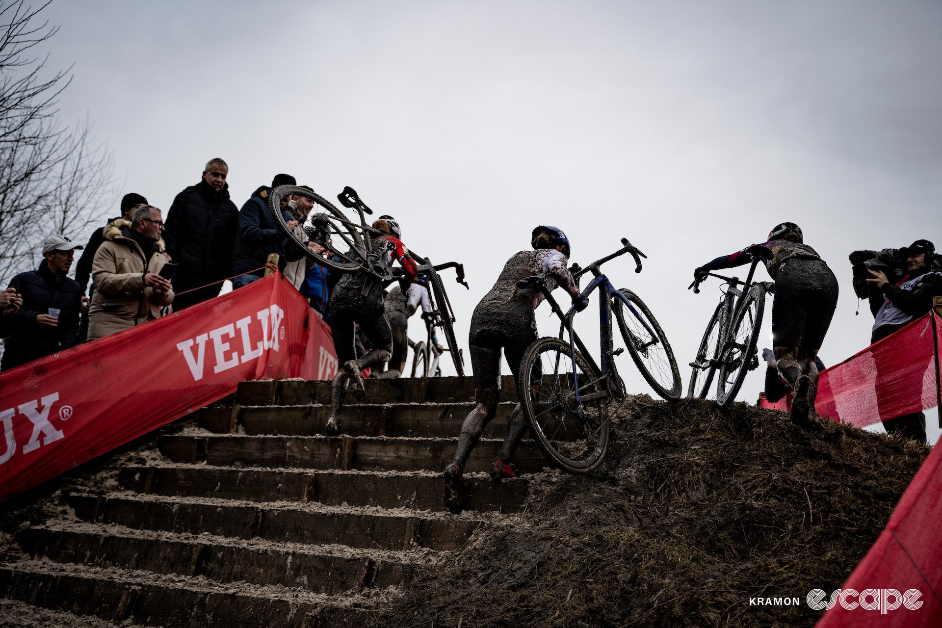 Puck Pieterse, Lucinda Brand and Blanka Vas seen from behind as they crest the short stairs during cyclocross World Cup Maasmechelen.