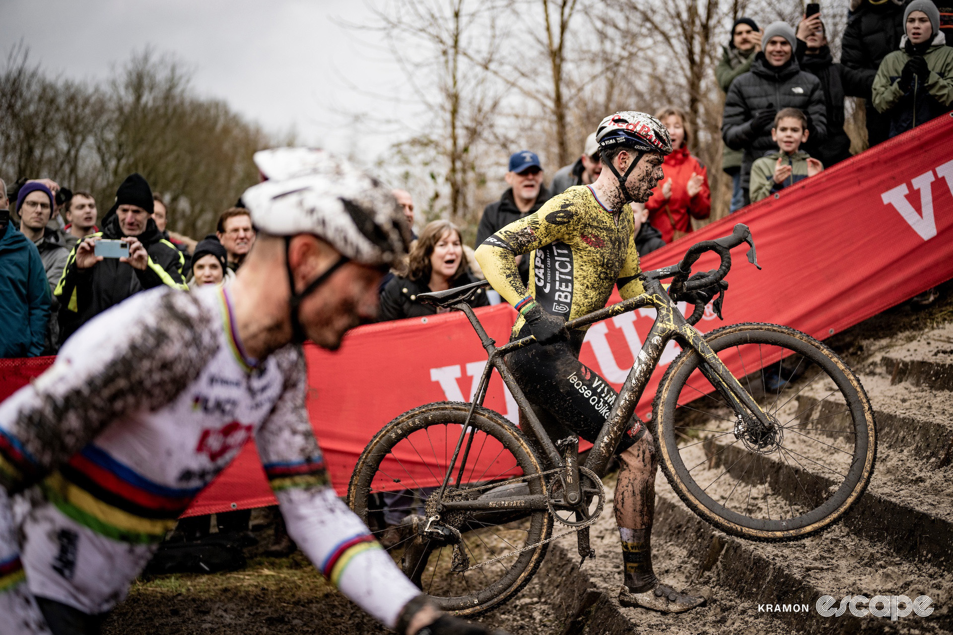 World champion Mathieu van der Poel and Wout van Aert run a short sandy flight of steps during cyclocross World Cup Maasmechelen.