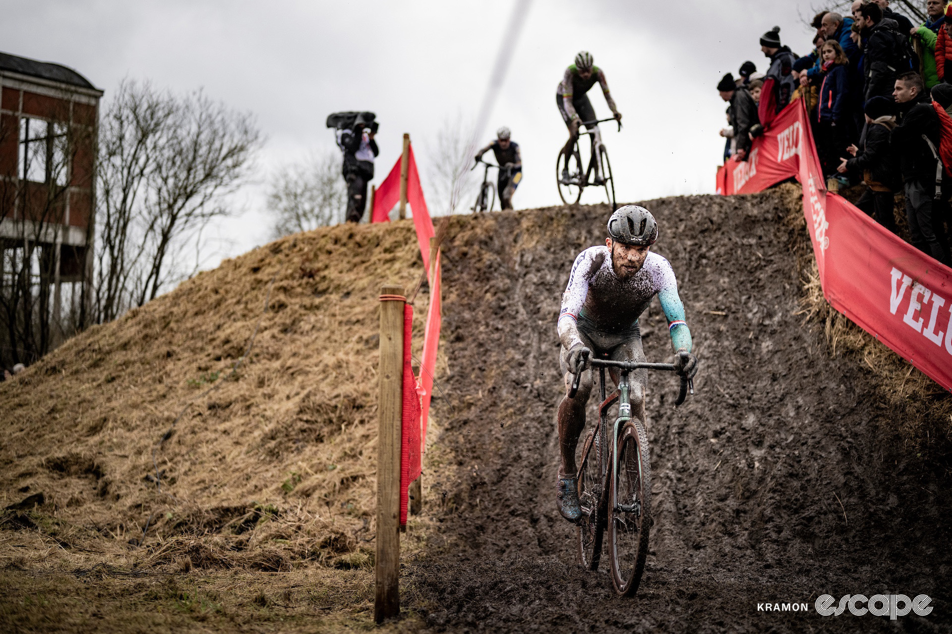 A muddy Joris Nieuwenhuis leads down a muddy ramp during cyclocross World Cup Maasmechelen.