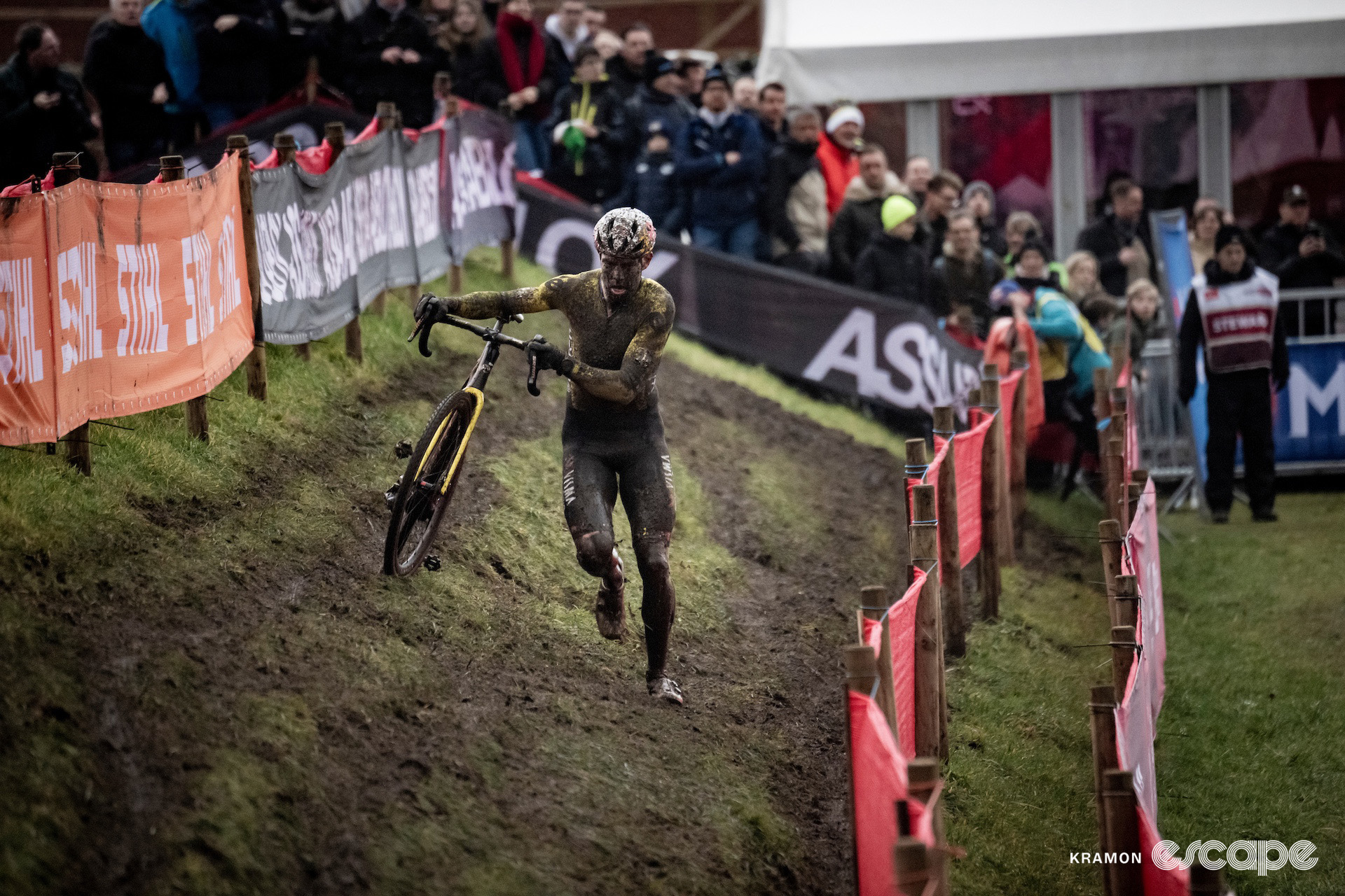 Wout van Aert, his kit and face obscured by mud, during cyclocross World Cup Maasmechelen.