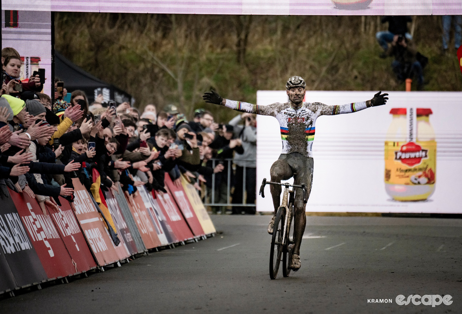 World champion Mathieu van der Poel throws his arms wide in celebration in the finishing straight at cyclocross World Cup Maasmechelen.