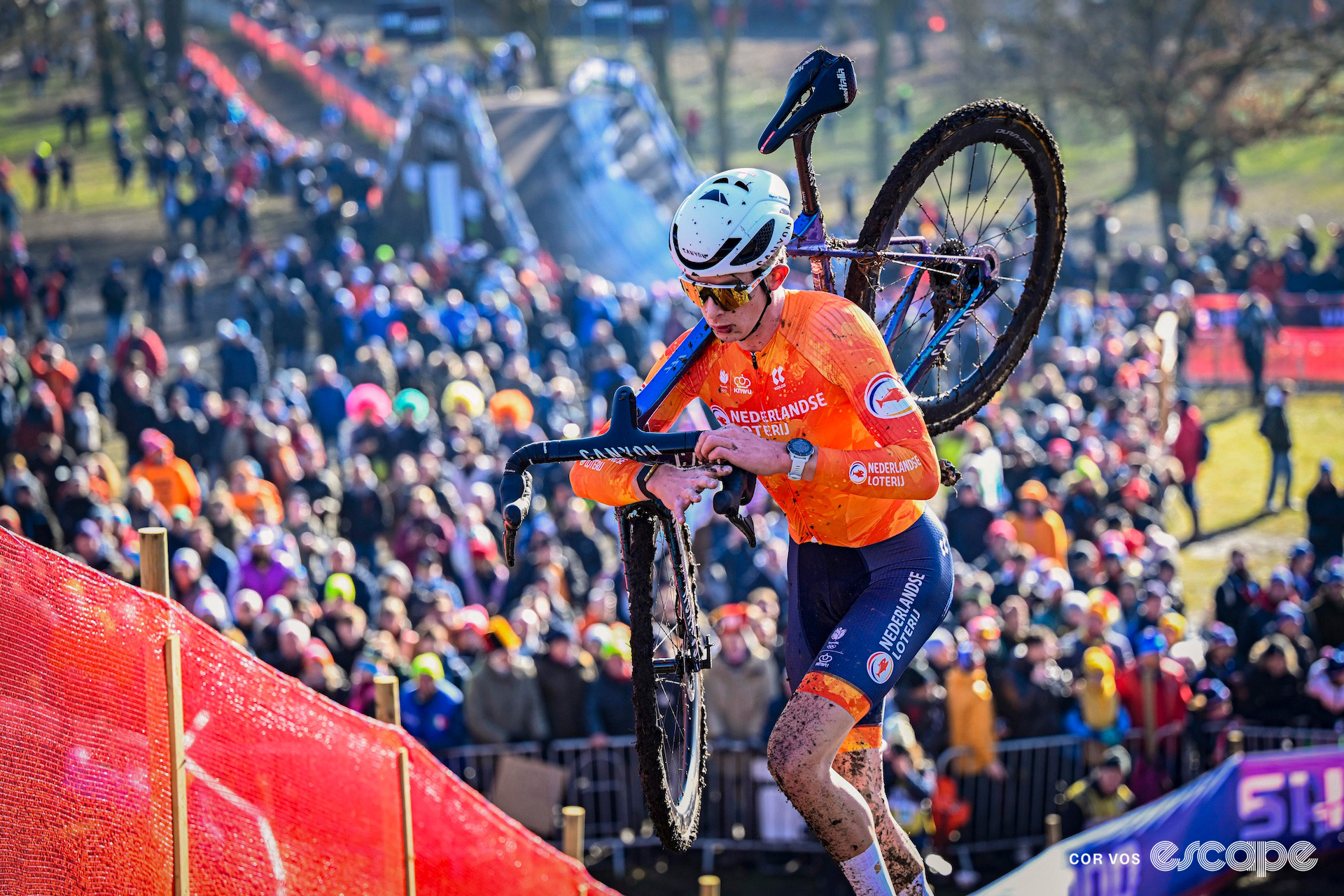 Tibor Del Grosso runs up a slope with his bike on his shoulder during the 2025 under-23 men's cyclocross World Championships.