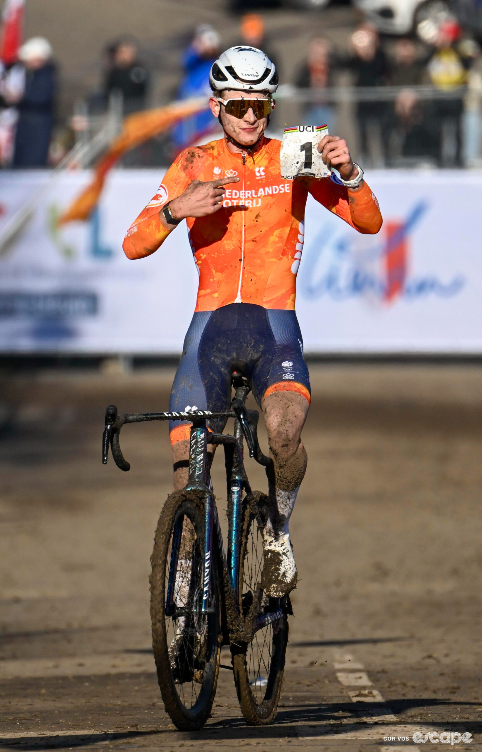 Dutch rider Tibor Del Grosso points to his number-1 jersey number as he approaches the finish line of the 2025 under-23 men's cyclocross World Championships.