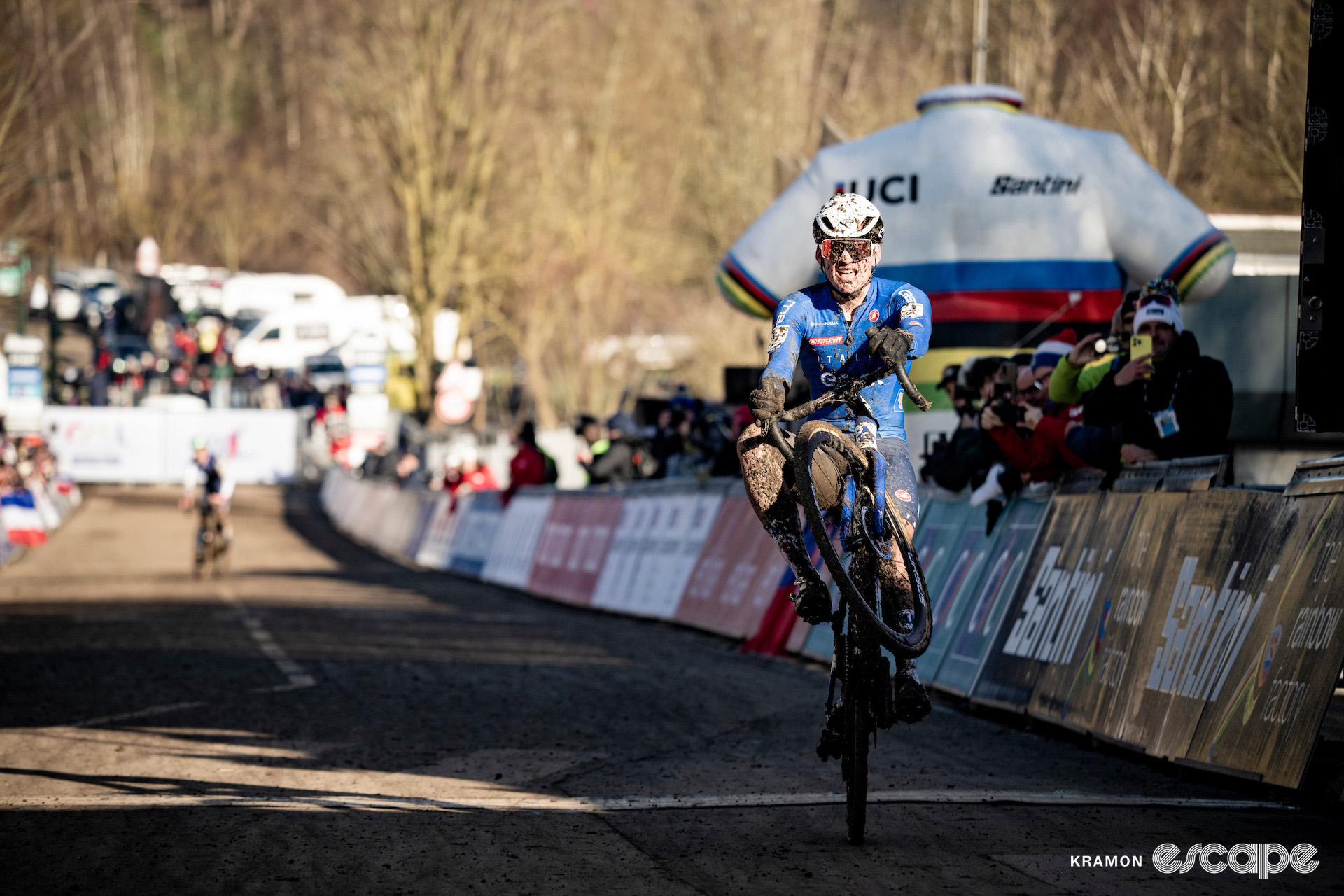 Italian Mattia Agostinacchio pops a wheelie as he crosses the line as winner of the 2025 junior men's cyclocross World Championships.