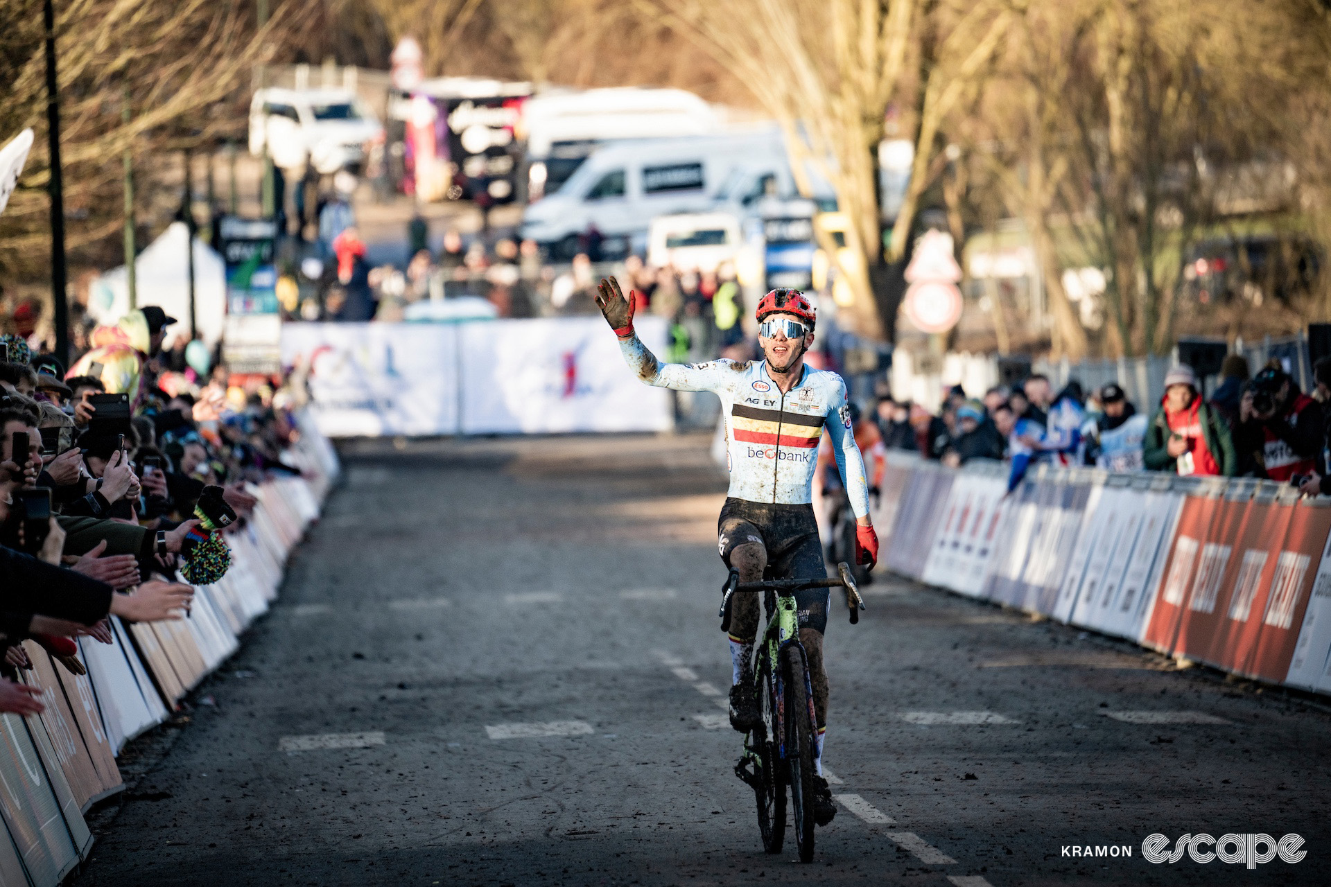 Thibau Nys waves to the crowd as he crosses the line third at the 2025 elite men's cyclocross World Championships.