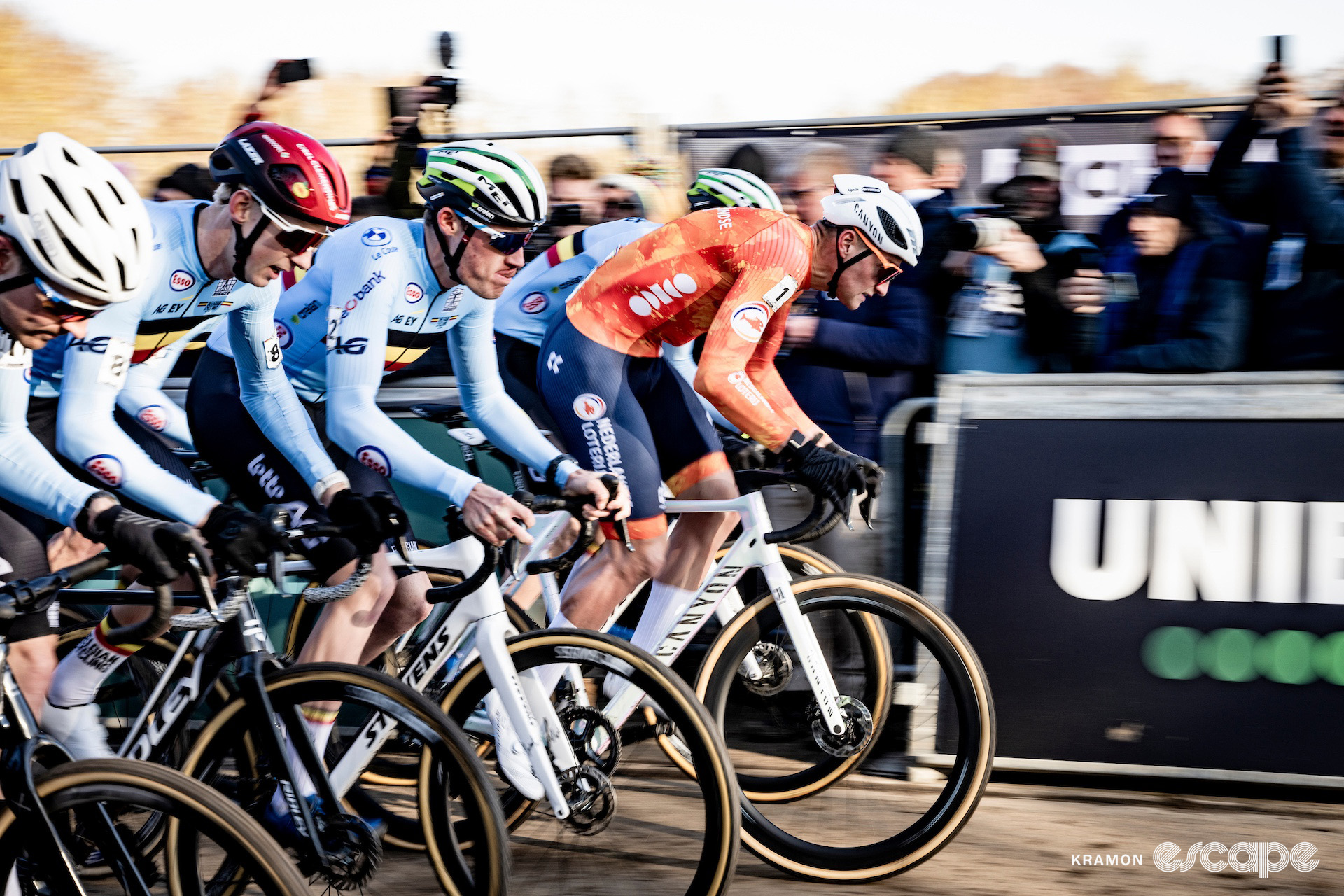 Dutchman Mathieu van der Poel accelerates off the line surrounded by Belgian jerseys at the start of the 2025 elite men's cyclocross World Championships.