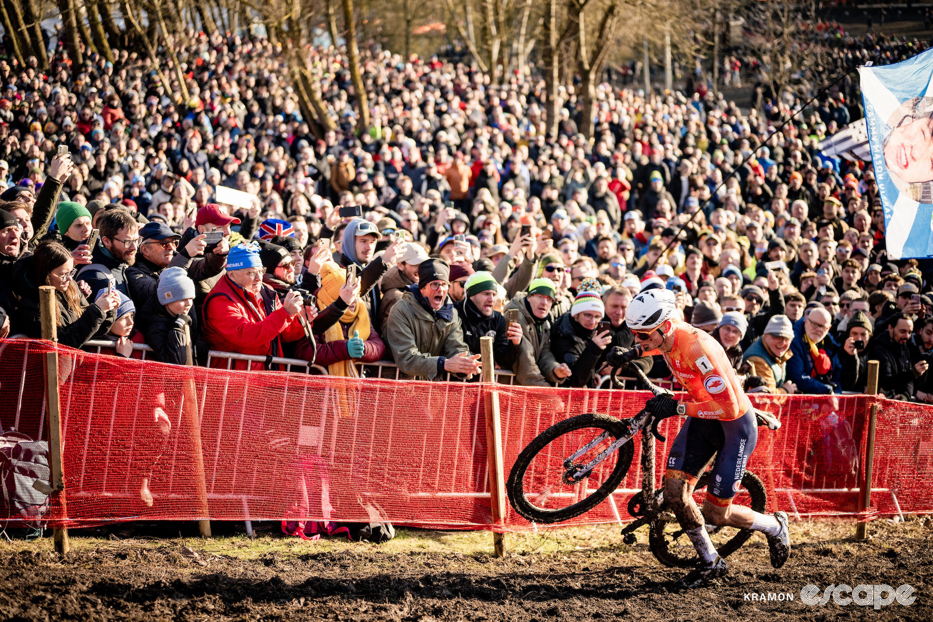 Mathieu van der Poel runs alongside a huge crowd during the 2025 elite men's cyclocross World Championships.