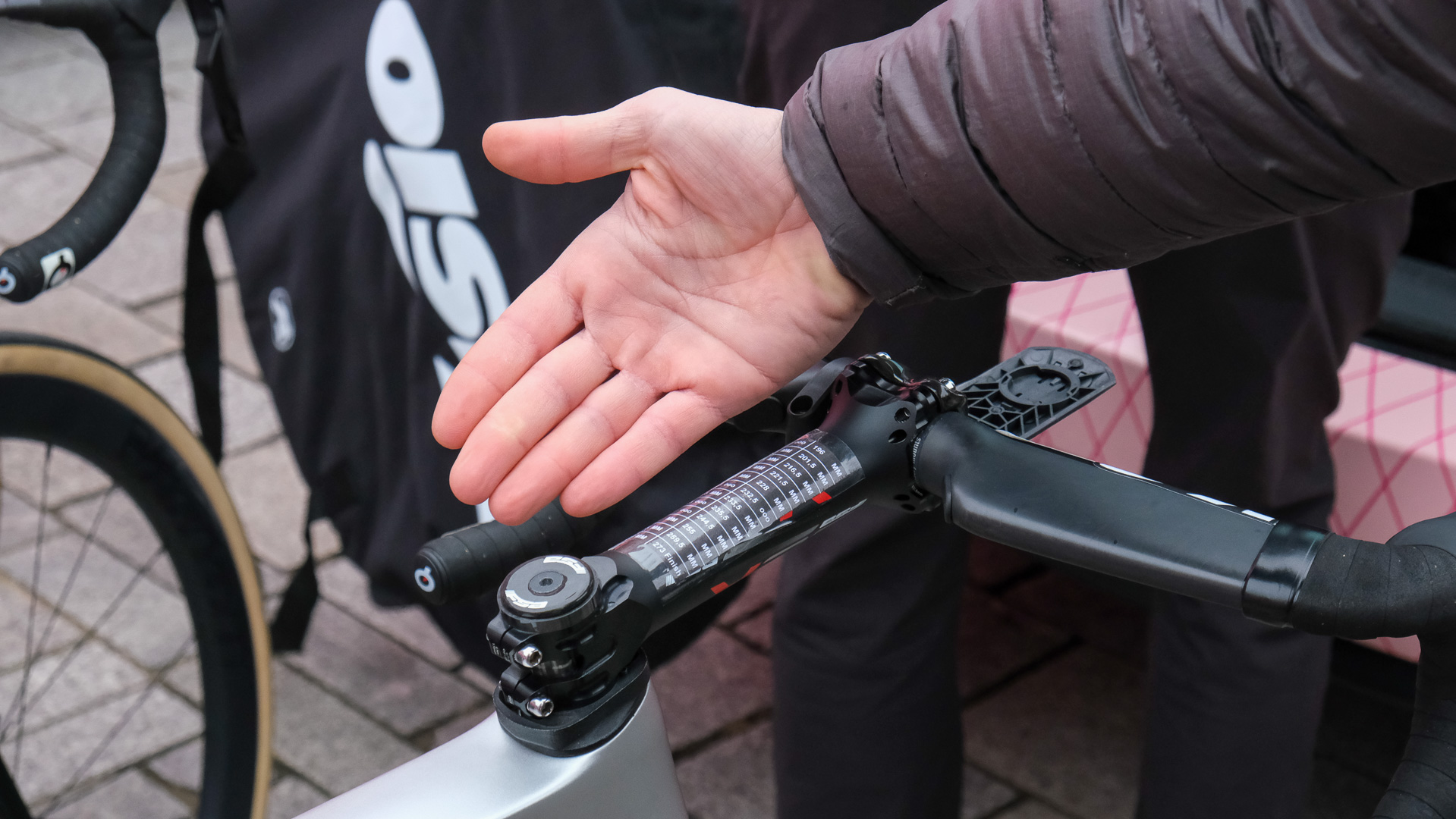 A view of an exceptionally long (140mm or more) stem on a pro rider's bike, shown to illustrate the aggressive riding positions pro riders use.