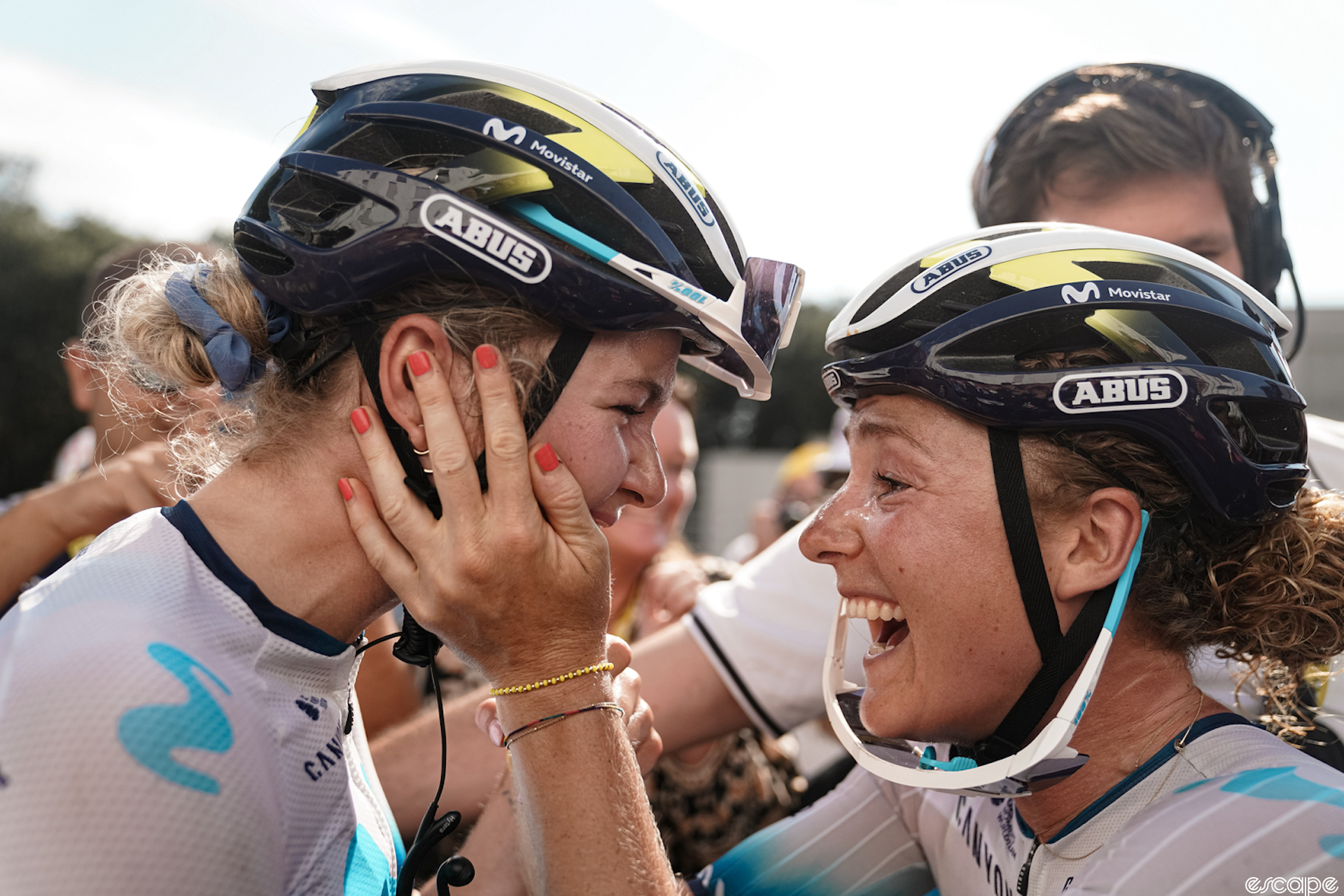 Floortje Mackaij clasps teammate Emma Norsgaard's face in her hands as they celebrate Norsgaard's TdFF stage win.
