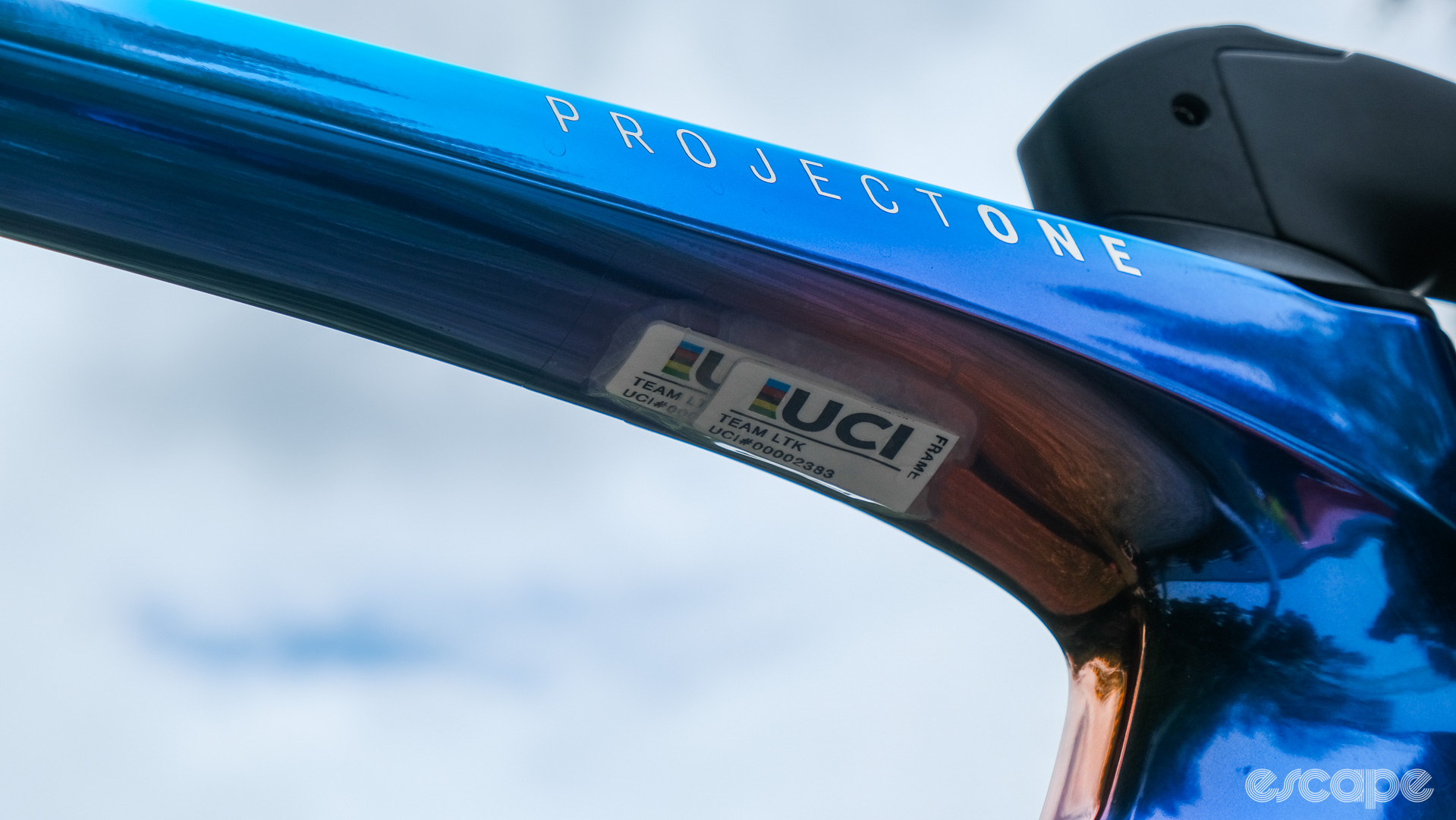 The photo shows a UCI equipment register RFID tag on the underside of the top tube on a Trek Madone at the Tour de France 