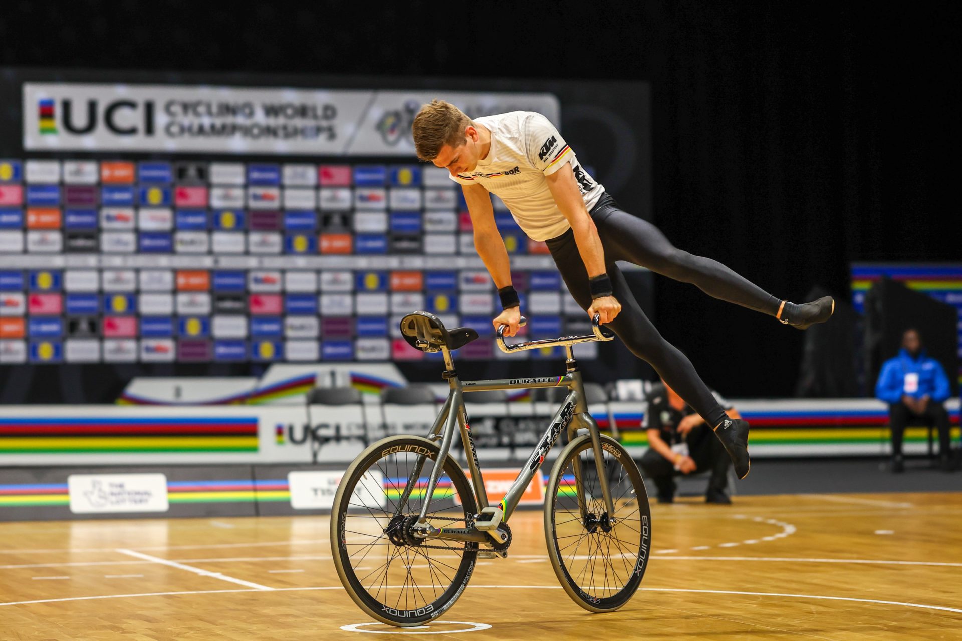 A German artistic cyclist in the men's final riding backwards, balancing himself on the handlebars.