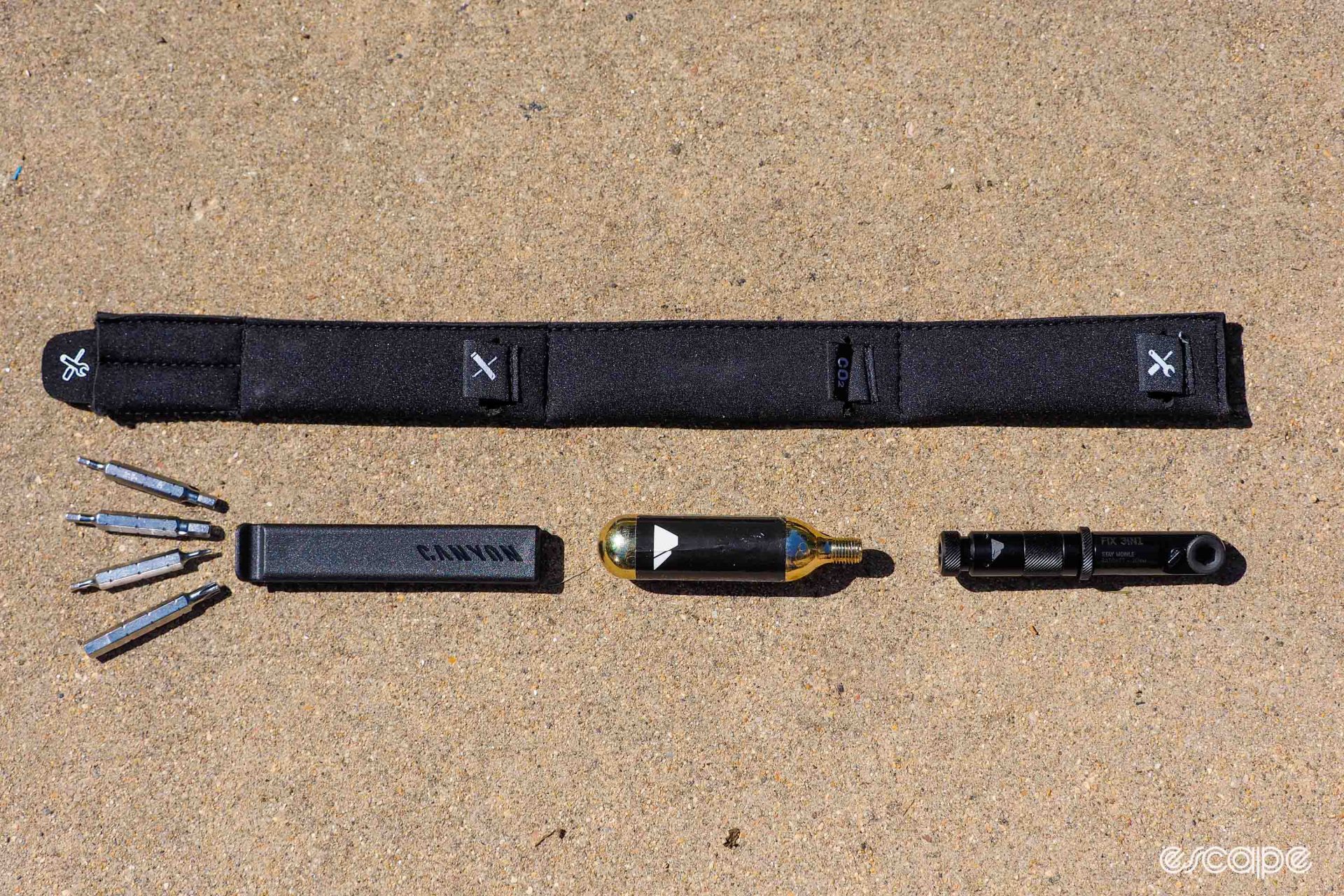 Canyon includes a neoprene sleeve to hold tools (not included) to fit in the storage compartment. The sleeve will fit a minitool with hex heads, CO2 cartridge, and tire lever, all shown here.