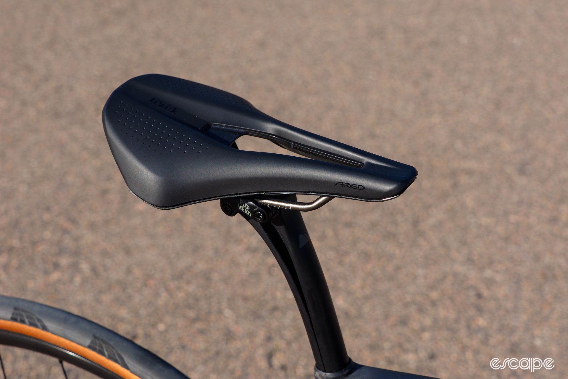 Fizik's Argo saddle features a stubby nose, wide and flat rear section and generous cutout.