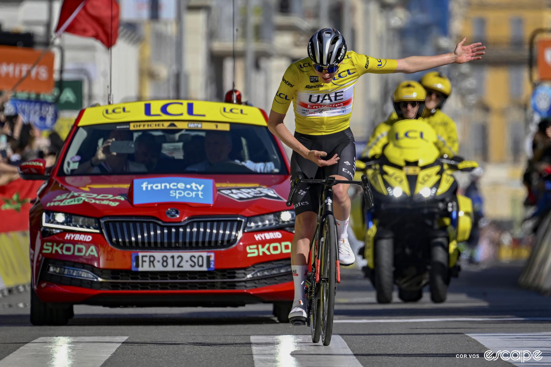 Pogačar, dressed in the yellow Paris-Nice leader's jersey, takes a bow as he wins a stage solo. 