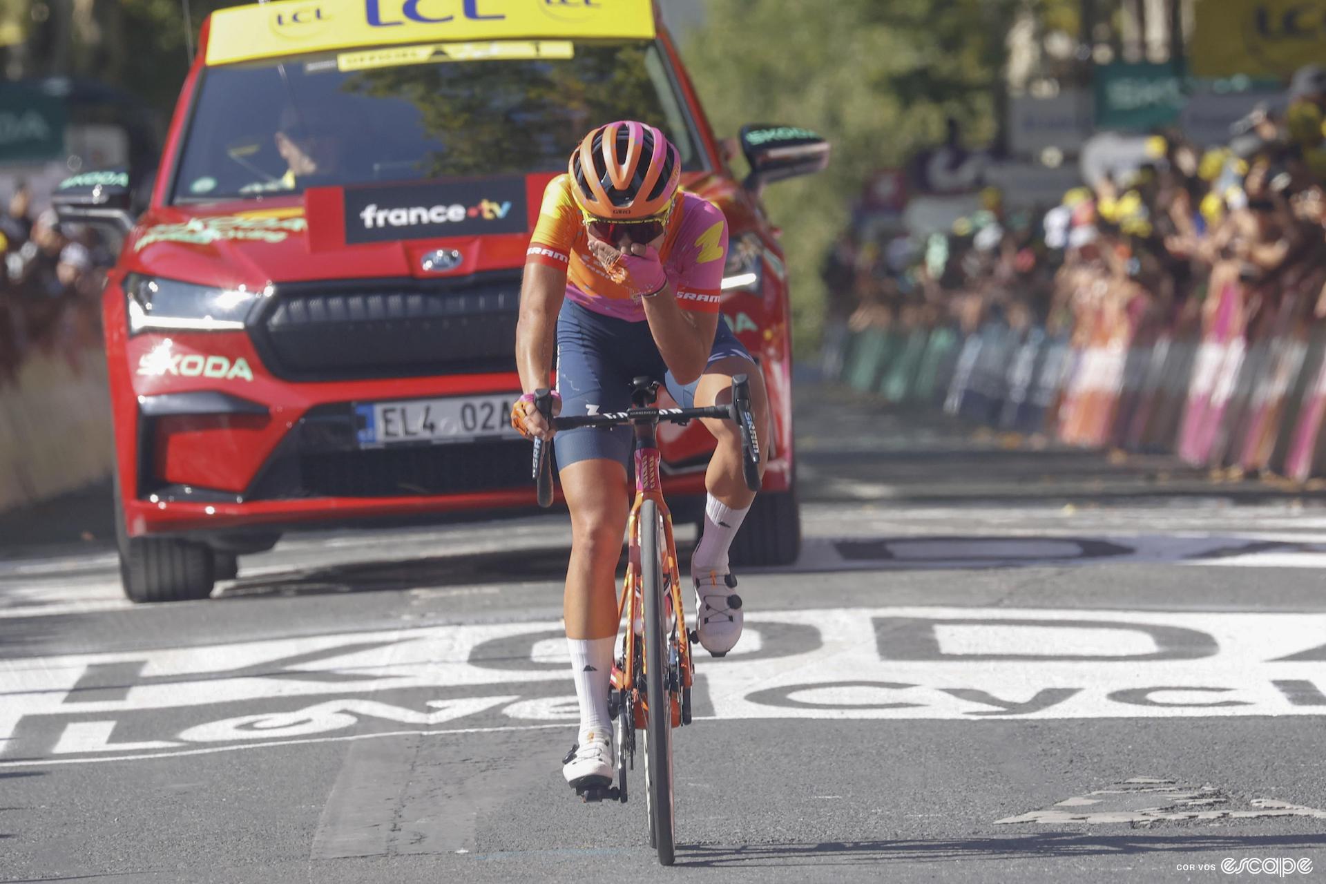 Ricarda Bauernfeind seems surprised to win stage 5 of the 2023 Tour de France Femmes. The Canyon-SRAM rider crosses the line alone from the breakaway and has her hand over her mouth.