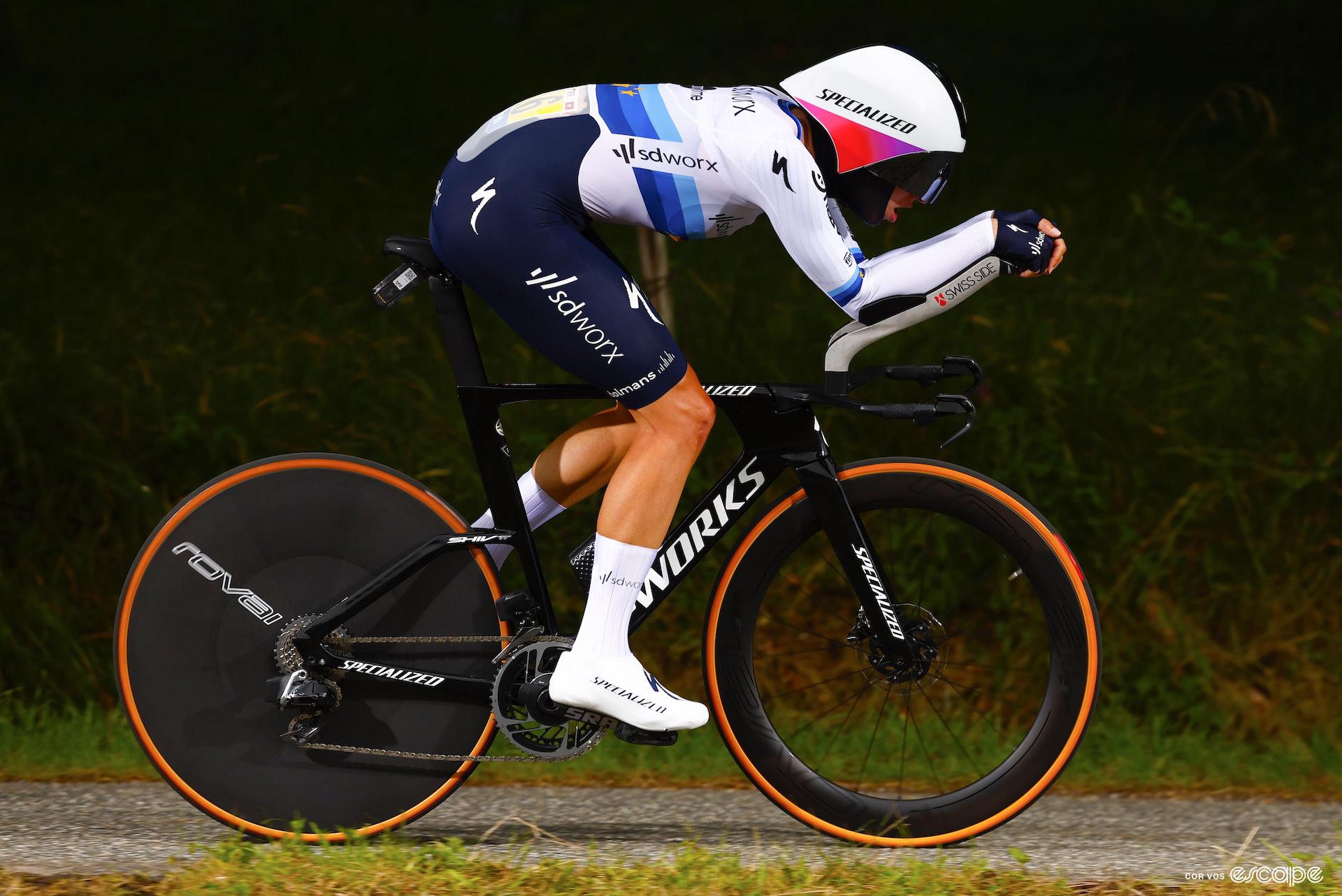Marlen Reusser on her time trial bike at the Tour de France, viewed from the side, in a highly aerodynamic position.