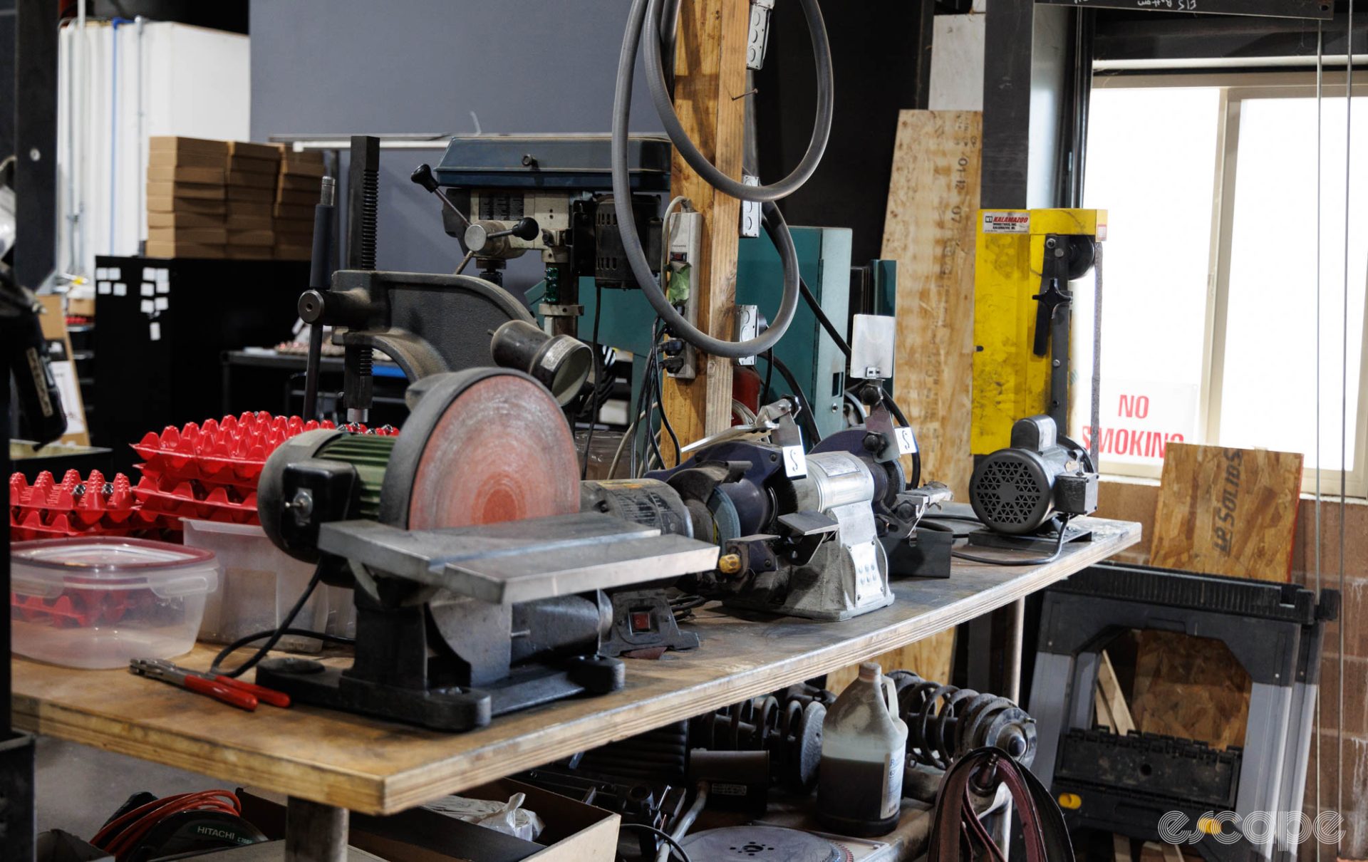Several hand machine tools sit on a large bench.