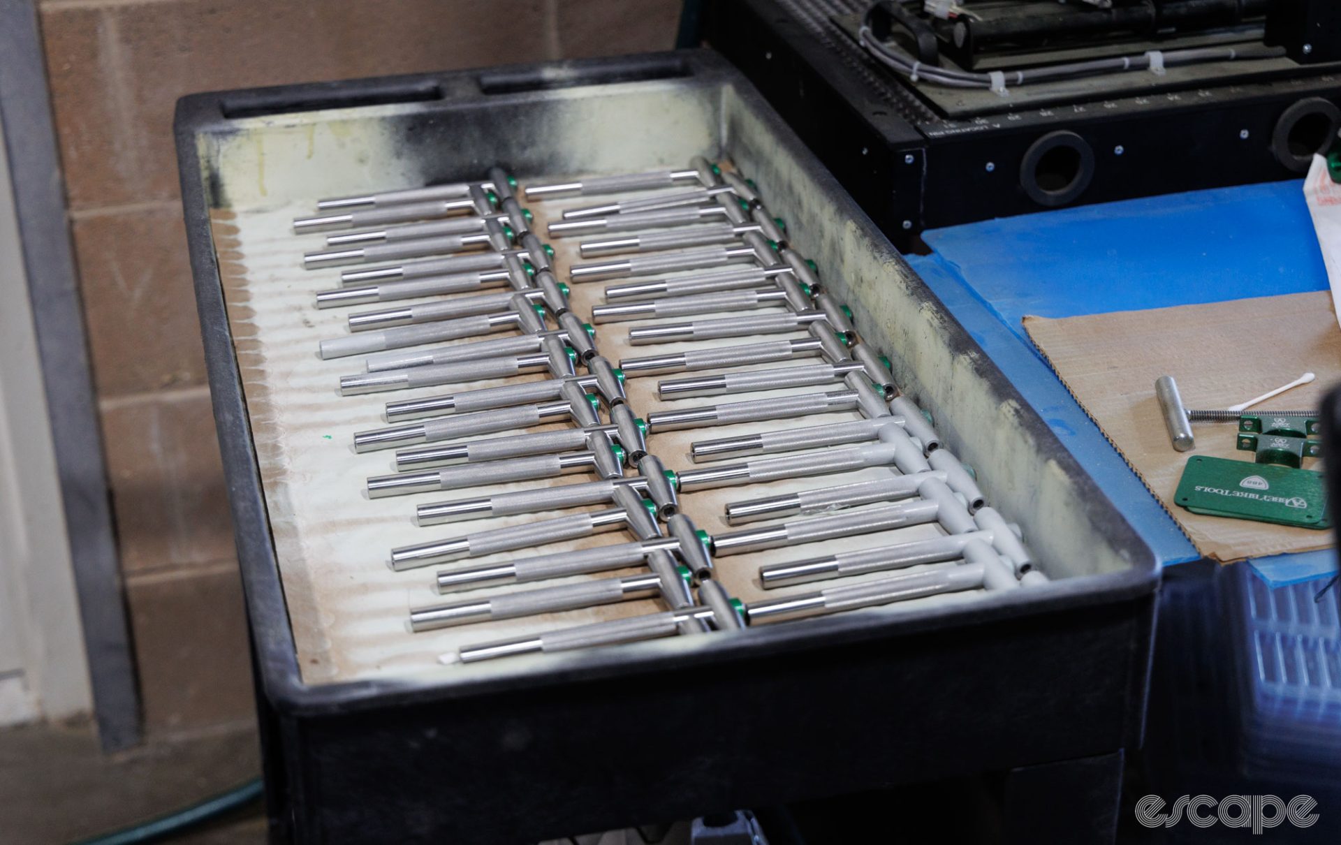 Neat rows of T-way tools sit in a container awaiting engraving.